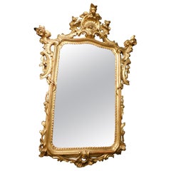 Mirror in lacquered and gilded wood, rich cymatium carved with shell, Italy