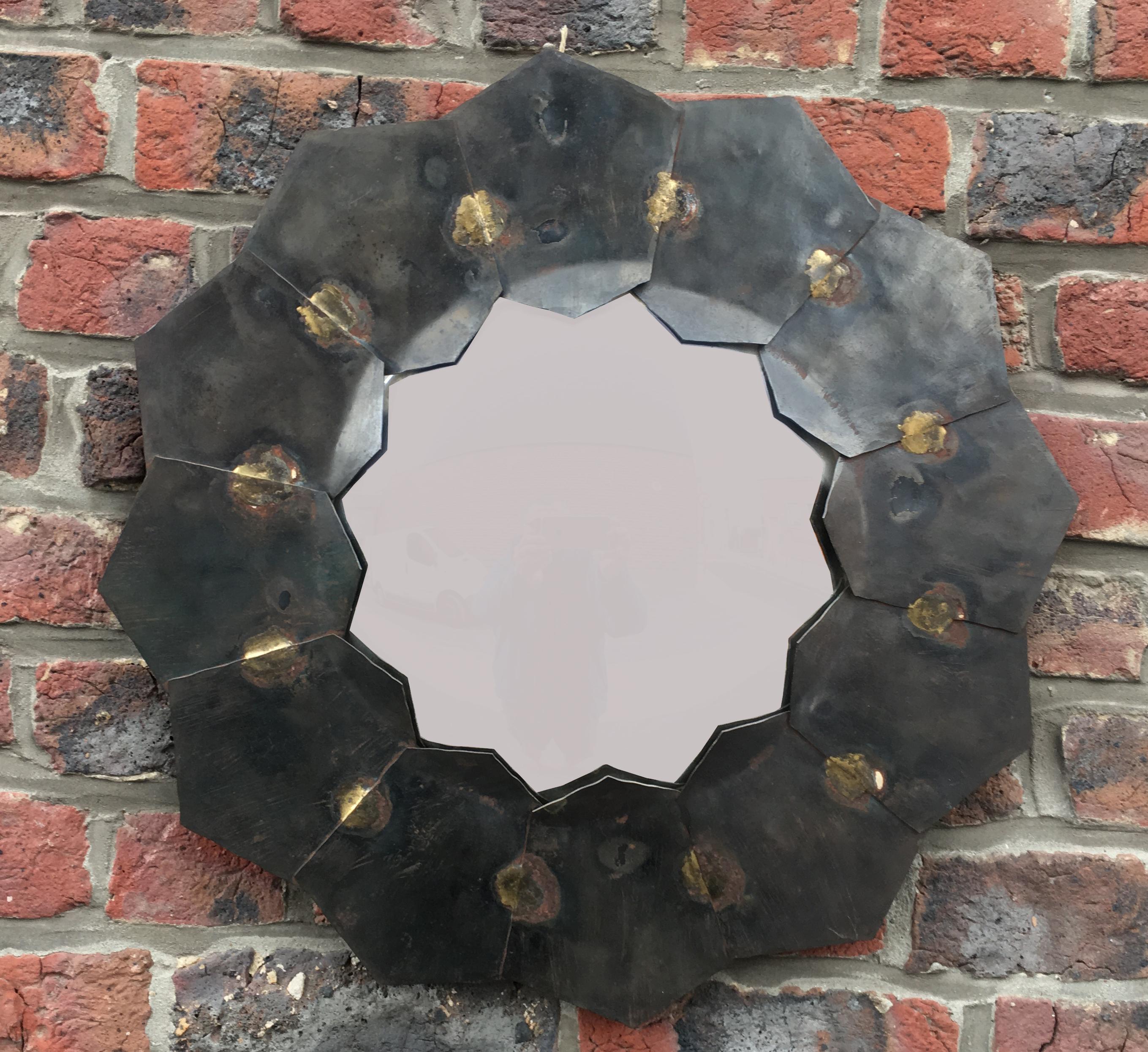 Mirror in patinated metal and brass, circa 1970.