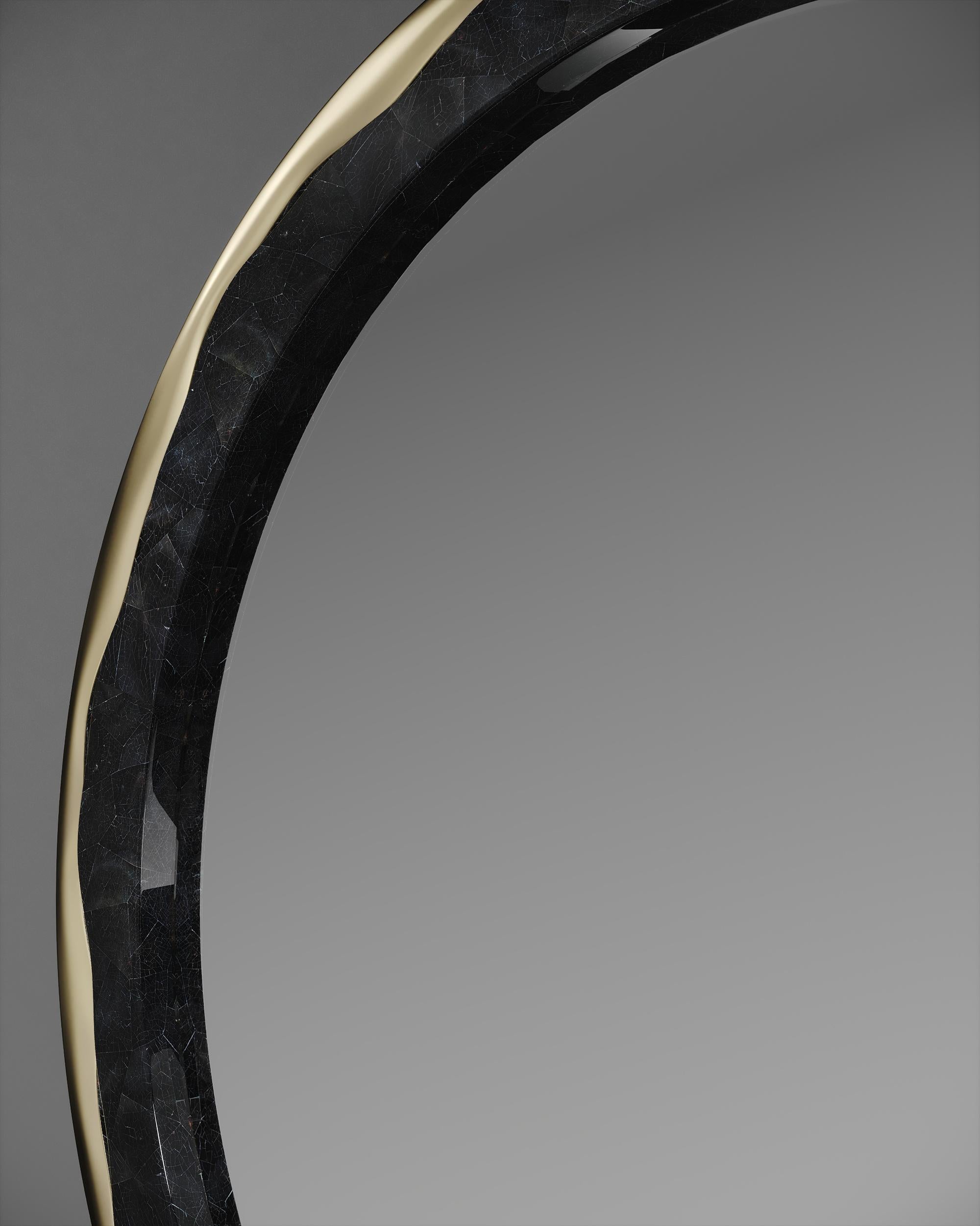 The melting mirror by R&Y Augousti inlaid in black pen shell and bronze-patina brass, is an iconic piece of theirs with their signature 