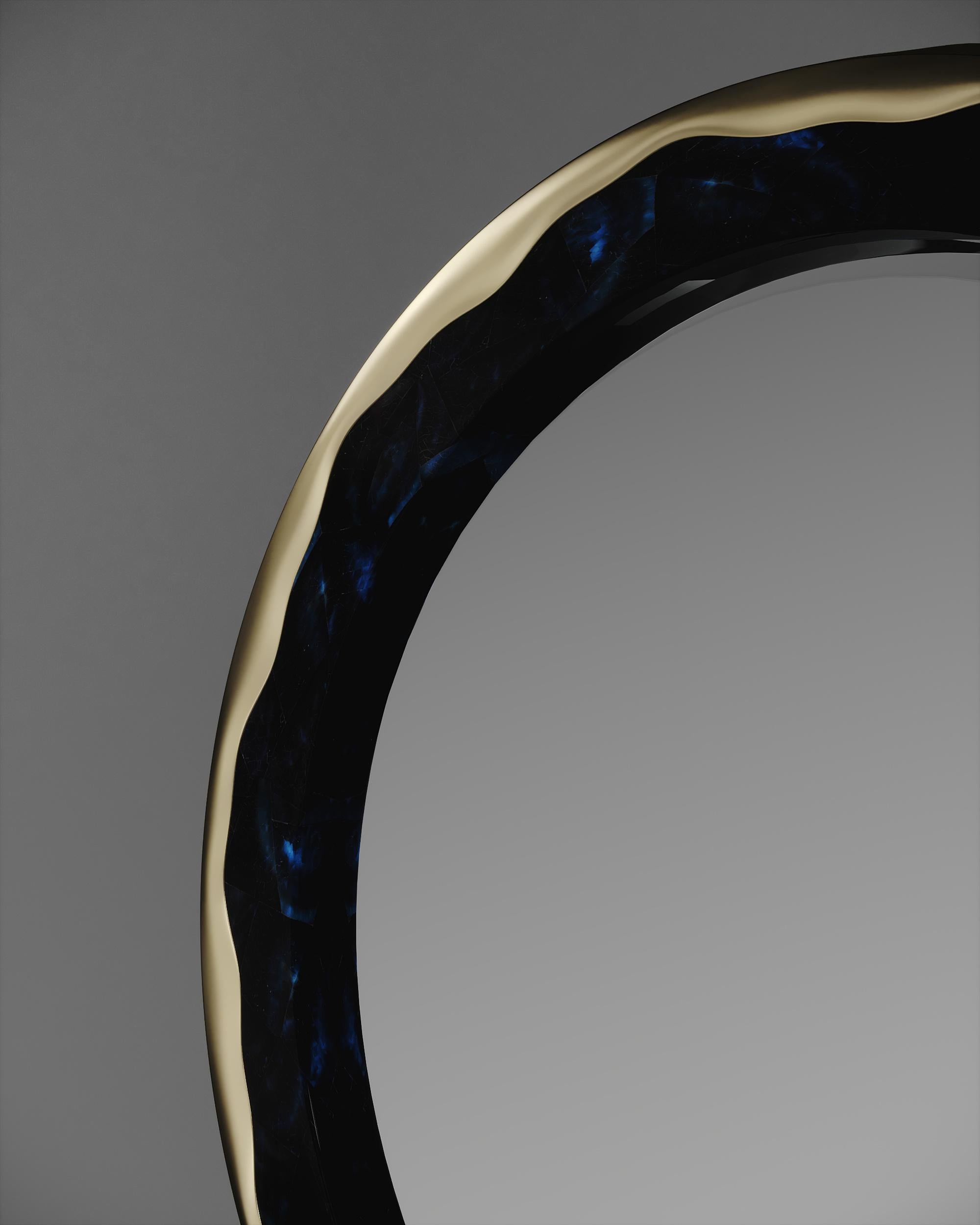 The melting mirror by R&Y Augousti inlaid in blue pen shell and bronze-patina brass, is an iconic piece of theirs with their signature 