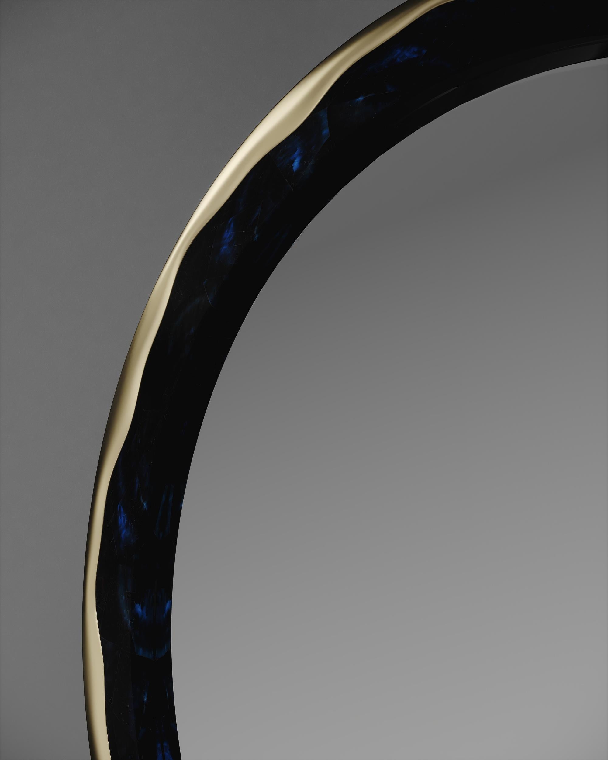 The melting mirror by R&Y Augousti inlaid in blue pen shell and bronze-patina brass, is an iconic piece of theirs with their signature 