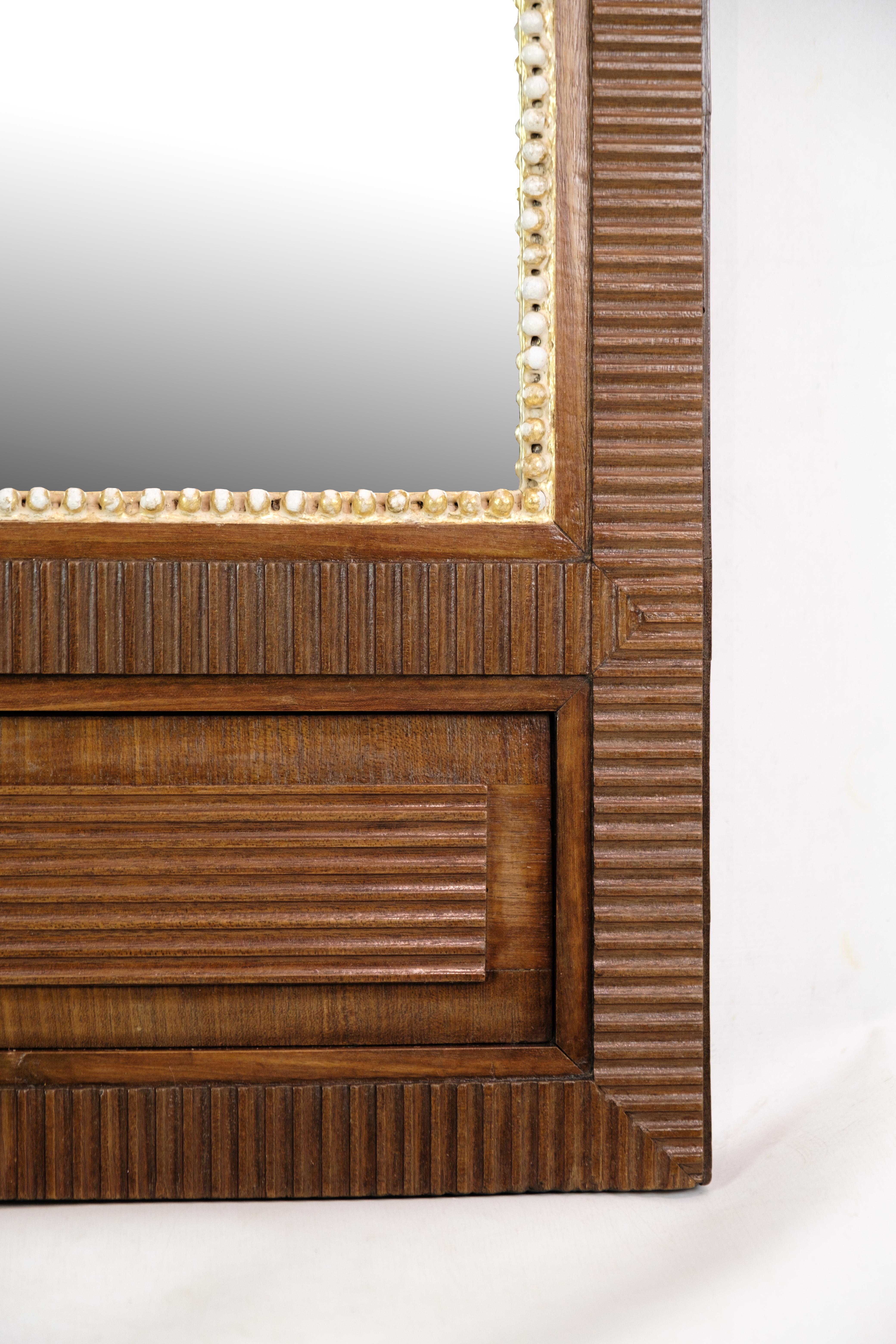 This Louis Seize mirror, crafted from mahogany in the 1780s, is a splendid example of the refined and elegant design characteristic of the Louis XVI period. The mirror's frame, made from rich mahogany wood, showcases the superior craftsmanship and