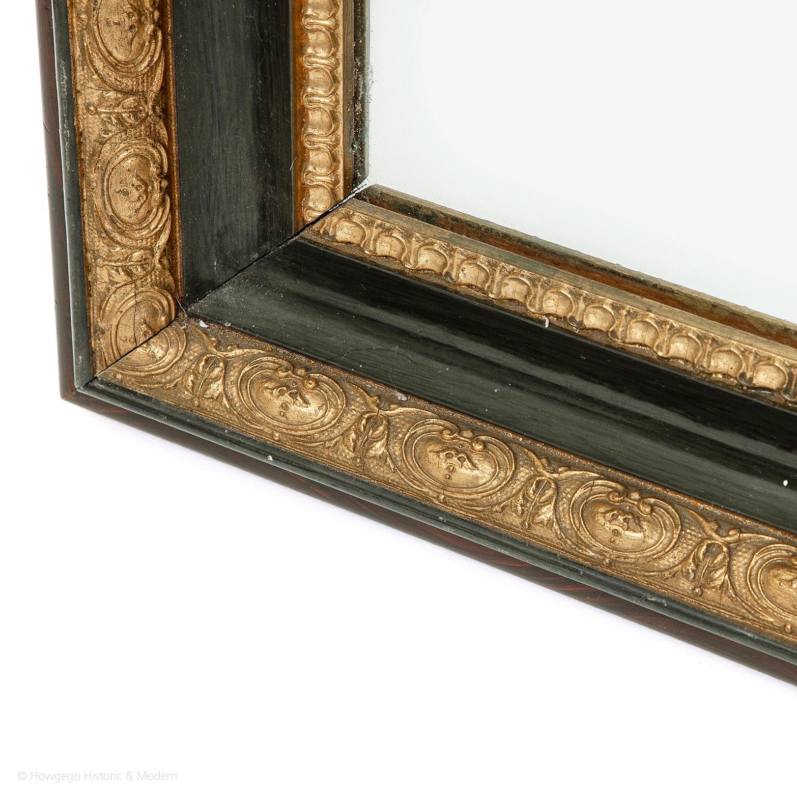 An early 19th century, green lacquered and woodgrained, neoclassical mirror with its original bevelled plate

The original bevelled plate surrounded by a gilded, moulded border. The cavetto frame with green lacquerwork decoration with fine