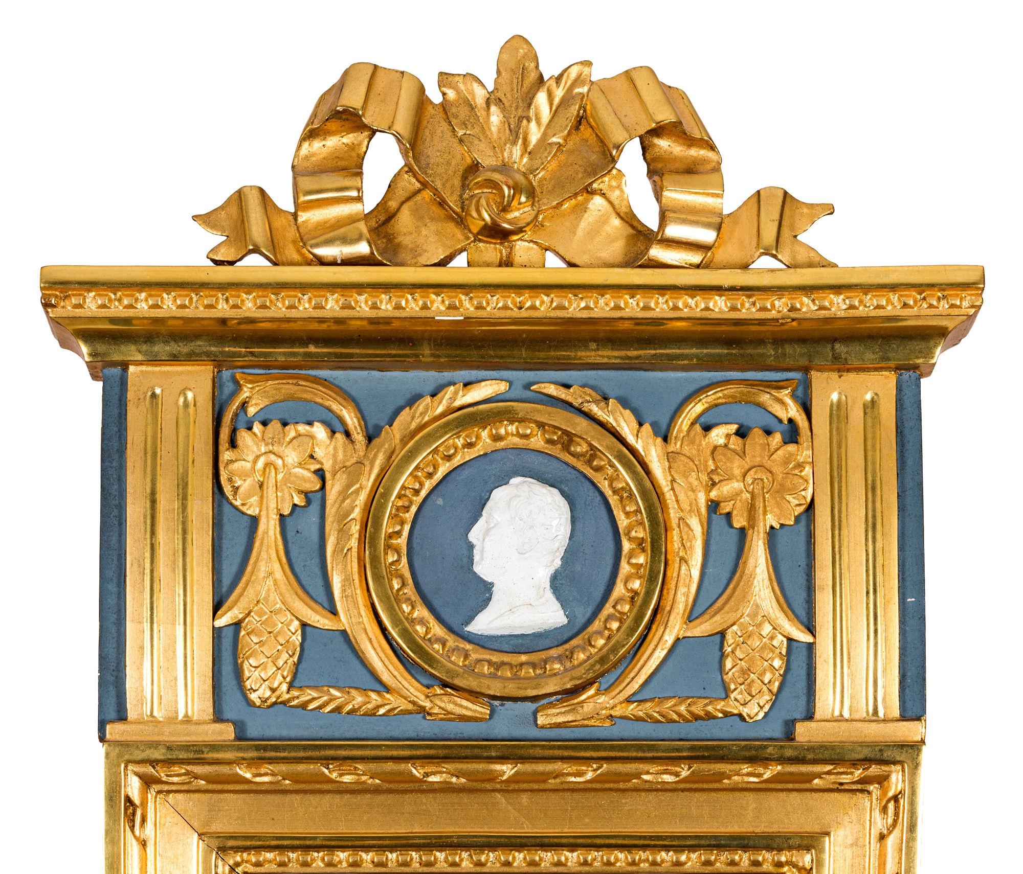Bedustavian Stockholm work, with Stockholm hallmark with date 1798 ?, bronzed and gilded, painted upper decorative field with medallion with men's profile, crowned band rosette, mirror edged with pearl bar, measures: 94 x 39 cm.
This diminutive