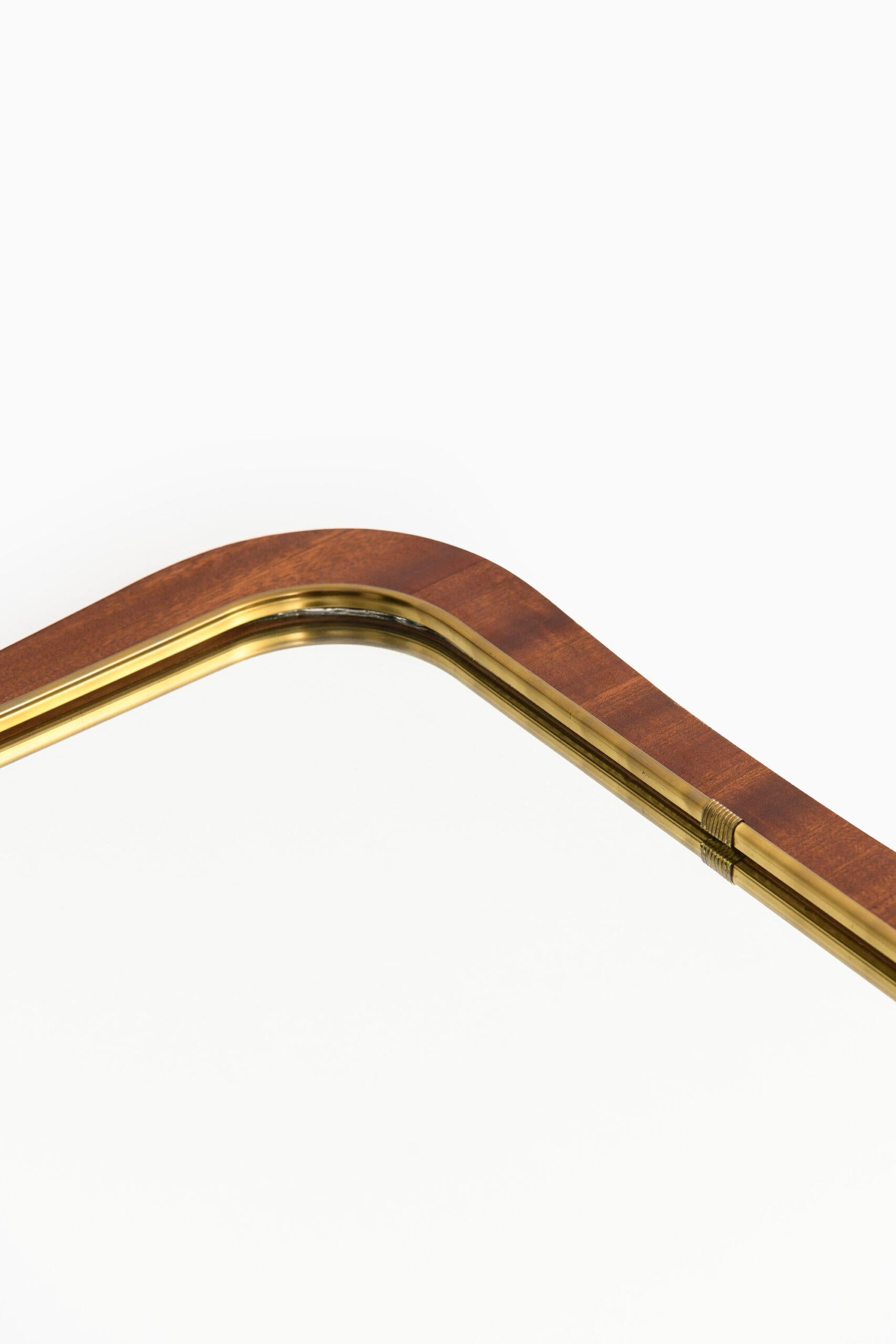 Mirror in mahogany and brass. Produced in Sweden.
