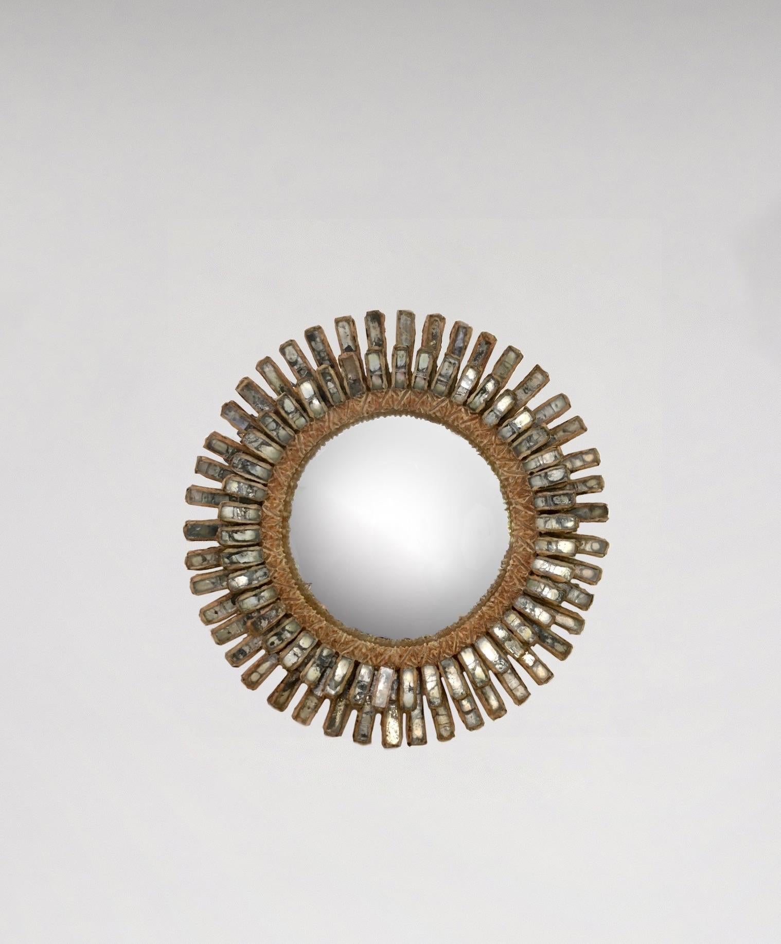 Mirror in talosel resin, mirror fragments and glass.
Incised to verso LINE VAUTRIN.
Diameter: 20.3 cm (8 in).
