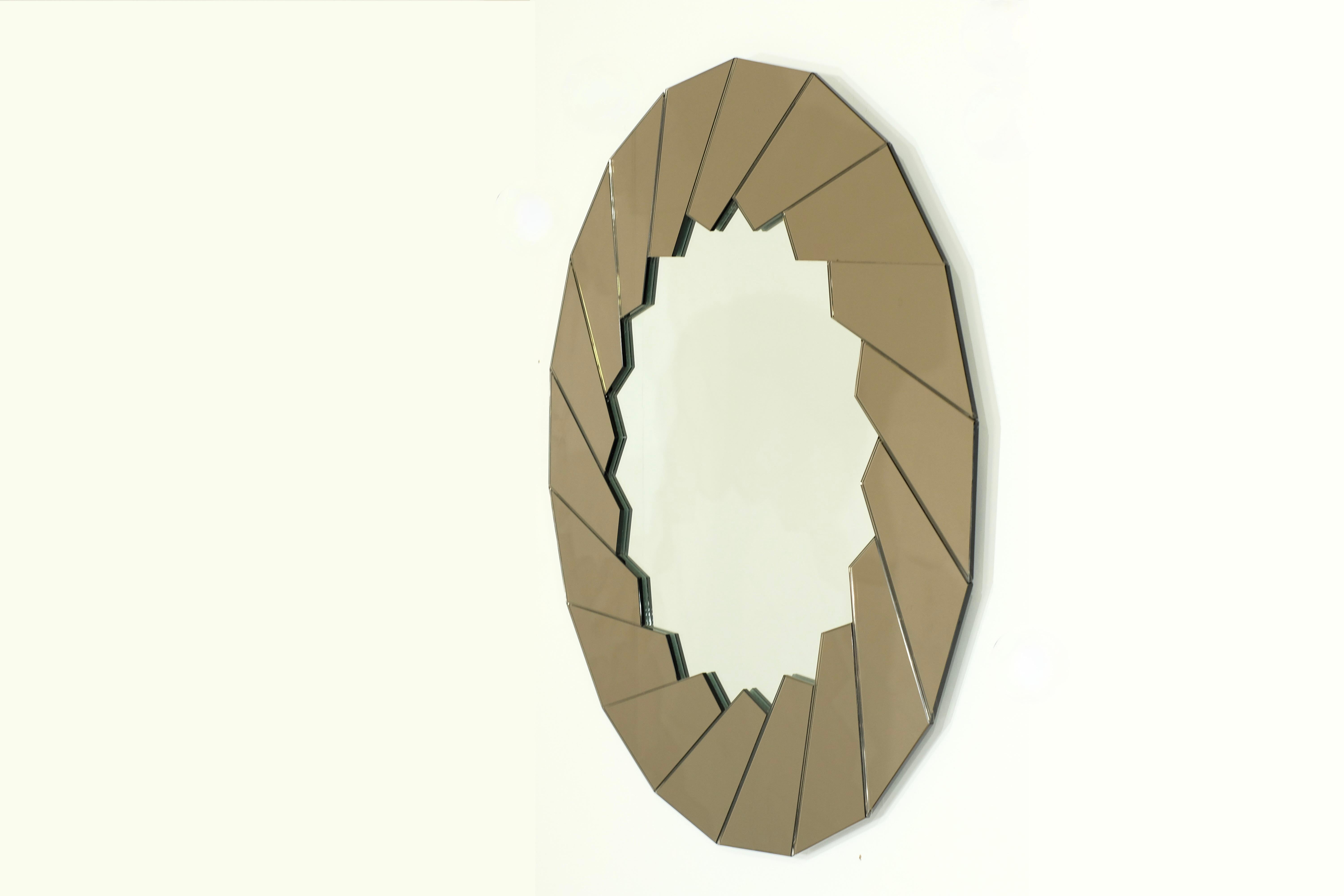 Amazing and rare Mirror by Gae Aulenti or Fontana Arte in the 1970s.

Polygonal mirrored glass wall mirror with lightly tinted mirror panes on the edge and a sun-shaped mirror cutout in the middle.

The color of the mirror it s a mix between light