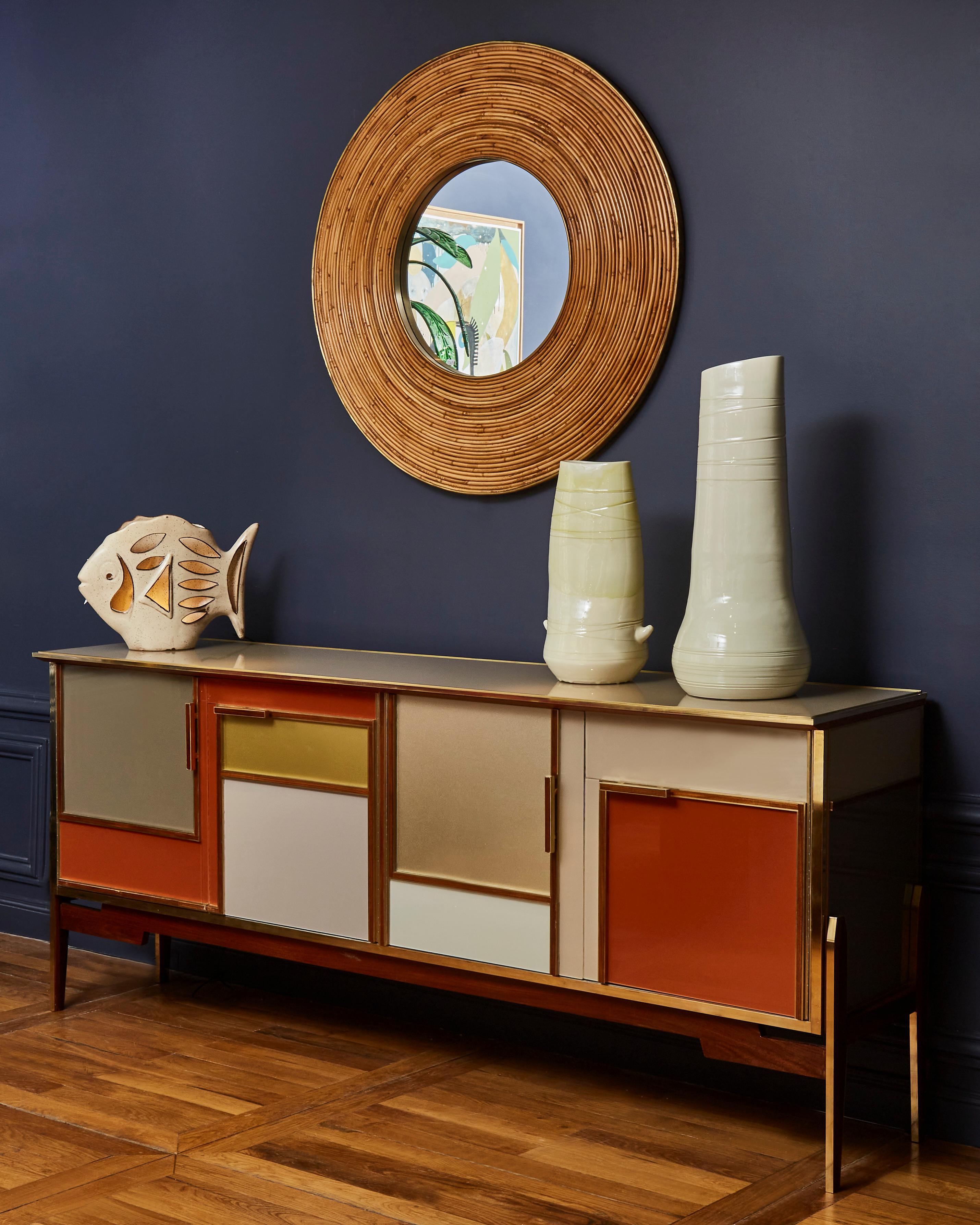Superb vintage wooden sideboard with 4 doors. Entirely restored and customized with brass and tainted mirrors by Galerie Glustin. 4 Brass feet.
Italy, 1970s.