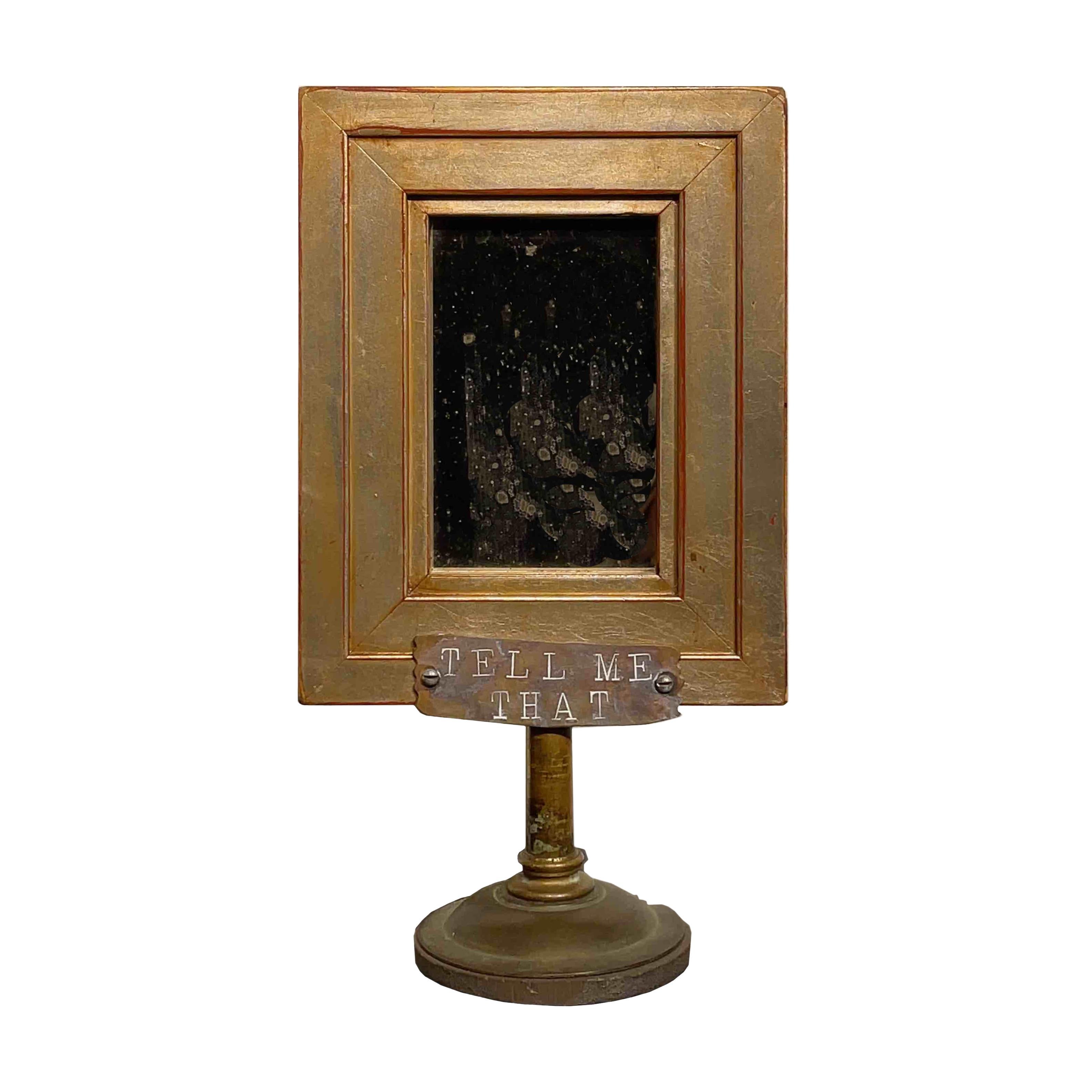 Self-taught artist John Seubert, AKA John Dolly, uses objects he uncovers as he rehabs older homes in Chicago. This piece has two handmade frames mounted back to back. Each side is a different treasure to discover. The front is a smoked mirror and