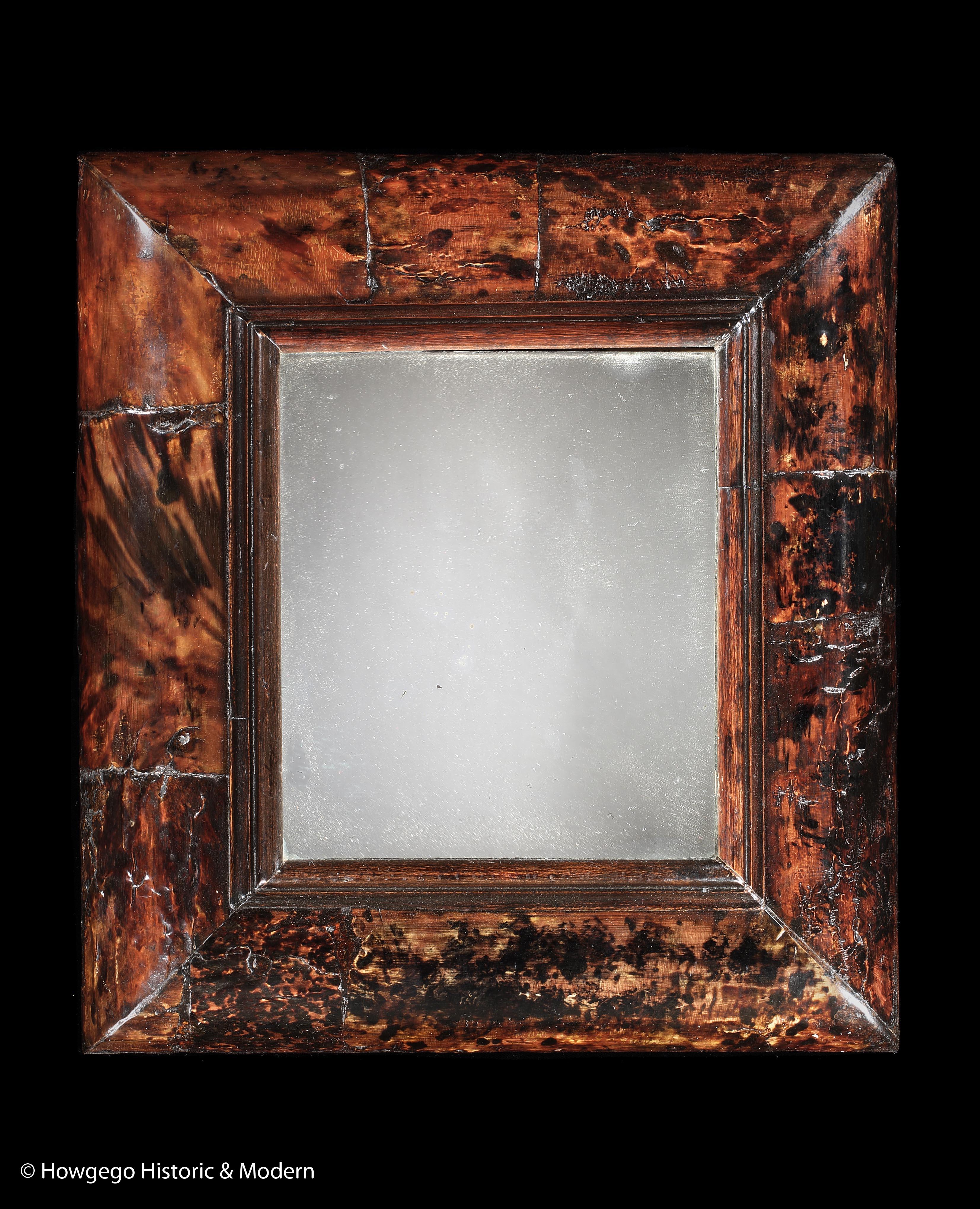 Rare, mid-17th century, Tortoishell, small, cushion framed, mirror with the original plate & back, length 14 ½” height 16”, depth 2½”
The tortoishell is striking and was highly prized as an elite, luxurious ornamental gem for its exotic nature and