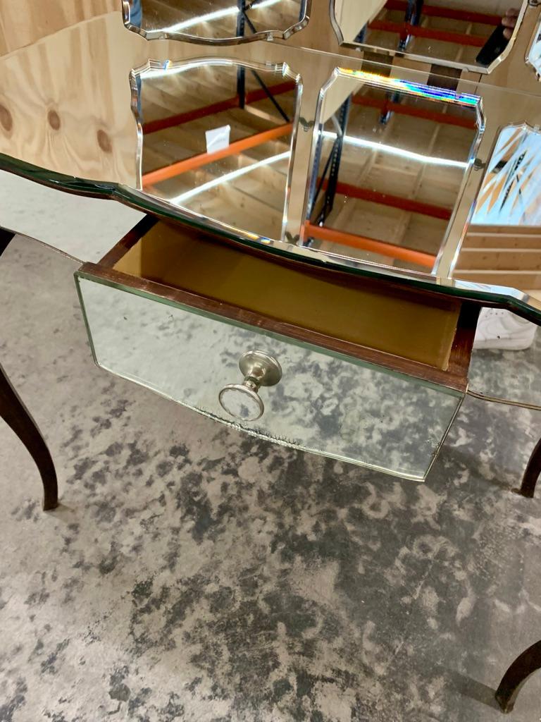 French vintage mirror vanity with wing mirrors and a drawer. The vanity has a lovely curved table top and is in very good condition - it has patina but no nicks or cuts.