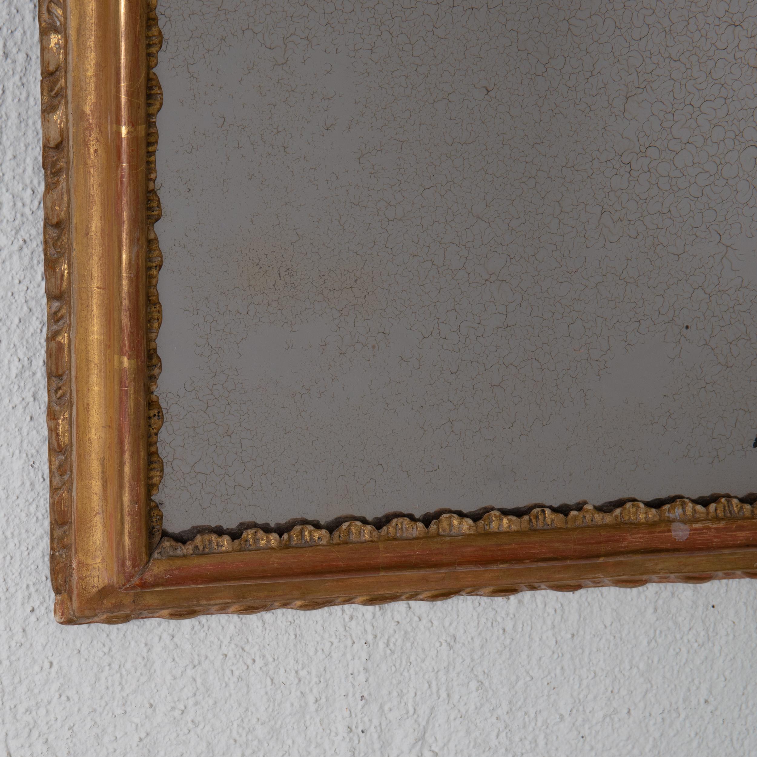 A beautiful mirror made during the Baroque period and early 18th century. All original gilding and mirror glass. Perfect for your powder room or above a single chair. Missing wood back.

 