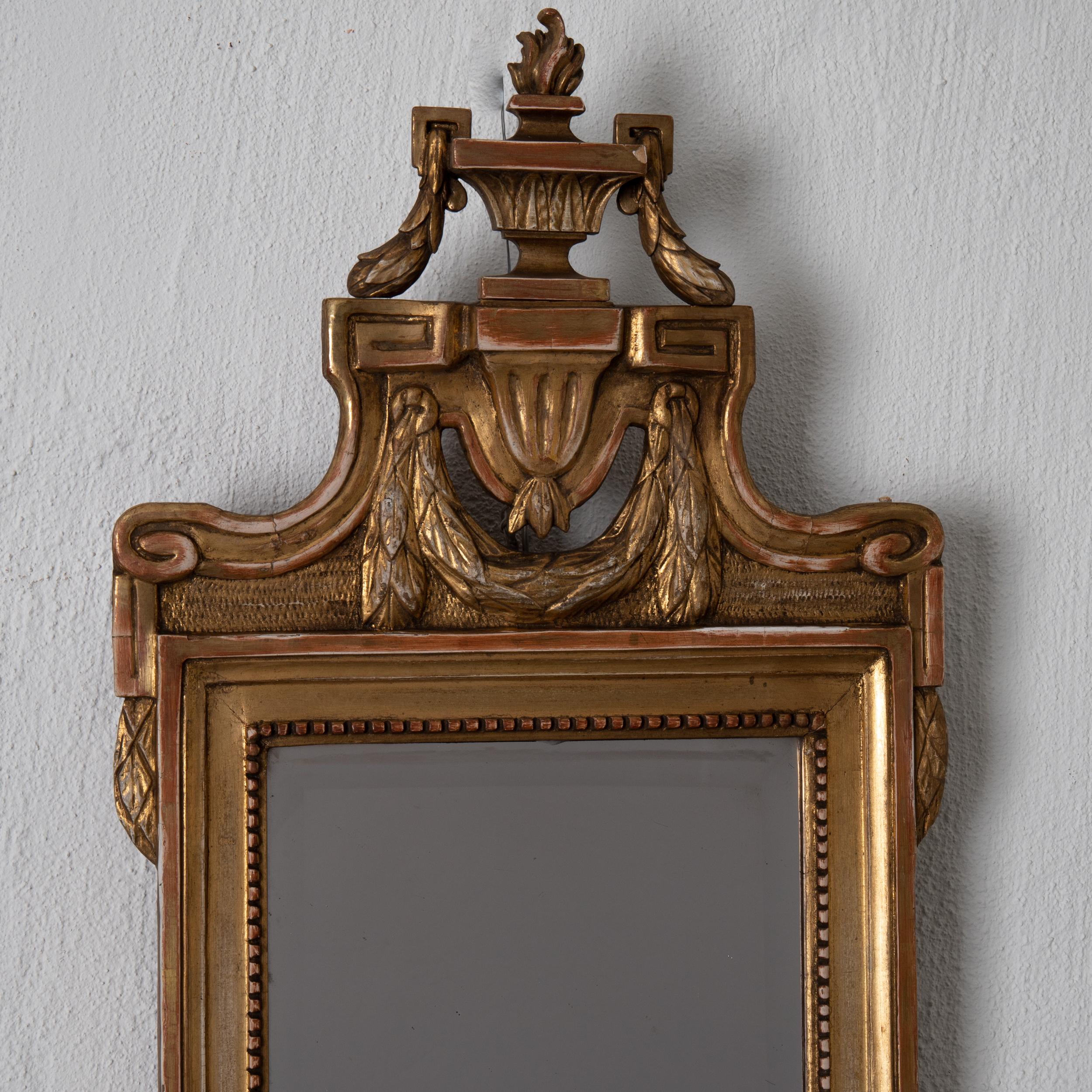 Mirror wall Swedish Gustavian gilded, Sweden. A gorgeous mirror made during the Gustavian period 1775-1810 in Sweden. Gustavian details such as the urn and laurel swags. Signed by mirror maker Niclas Falkengren, Jönkoping, Sweden, 1750-1813.
 