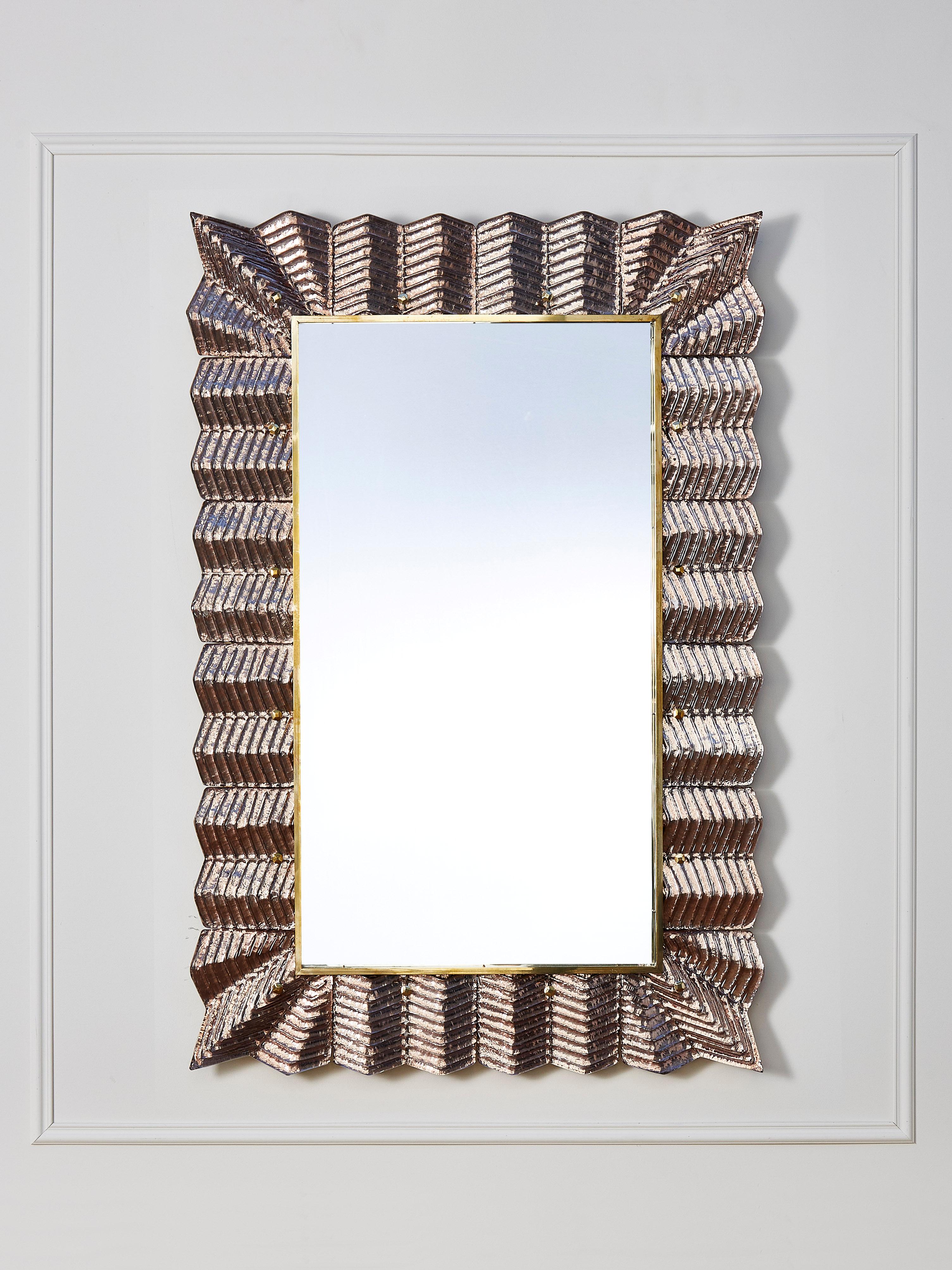 Mirror with a frame made of brass and sculpted copperish Murano glass. 
Creation by Studio Glustin.
Pair available.