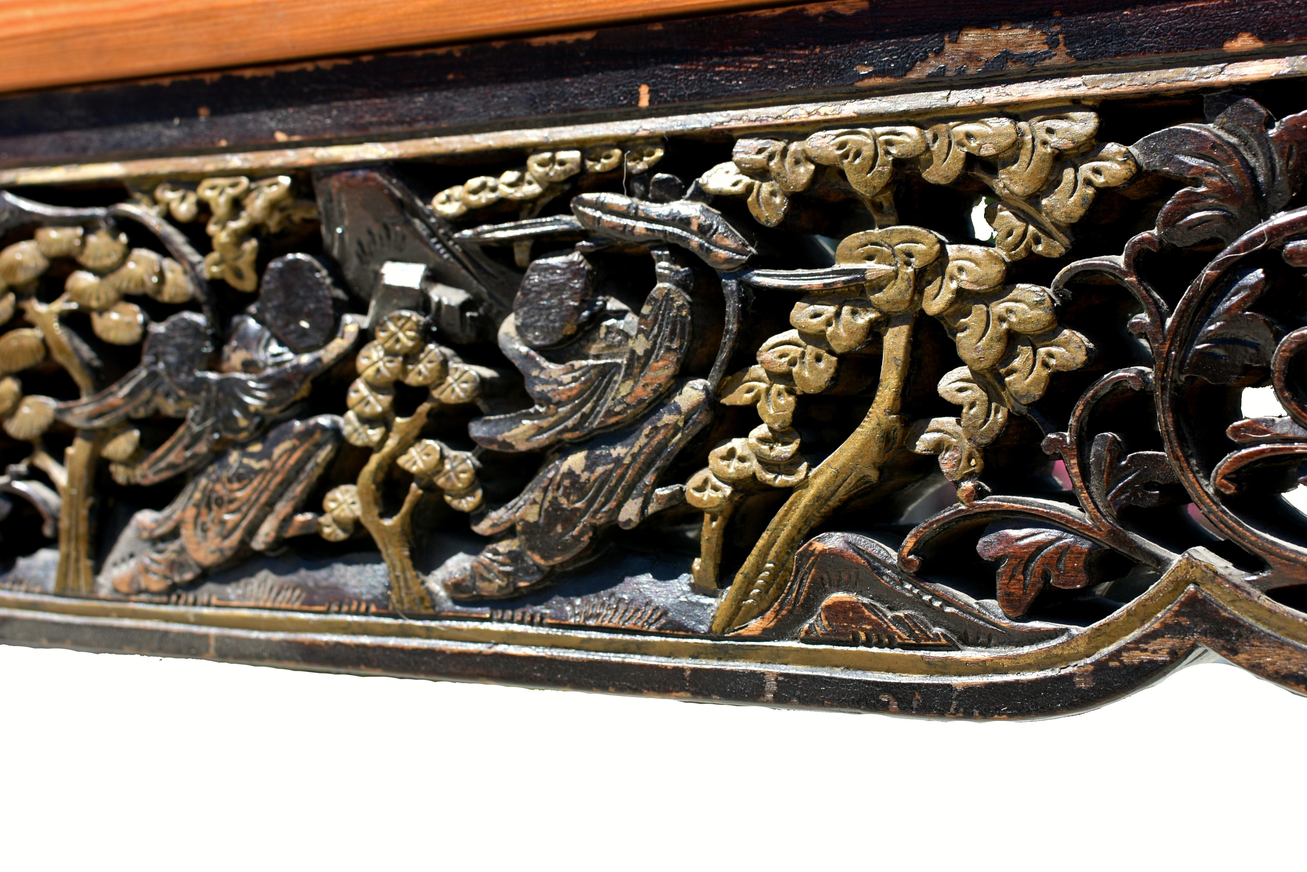 A beautiful solid wood mirror framed with a fine 19th century carving. The elaborate design features He He, the Harmony Gods, set among flowing grapevines heavy with a rich harvest, symbolizing abundance and harmony. The carving is finely detailed