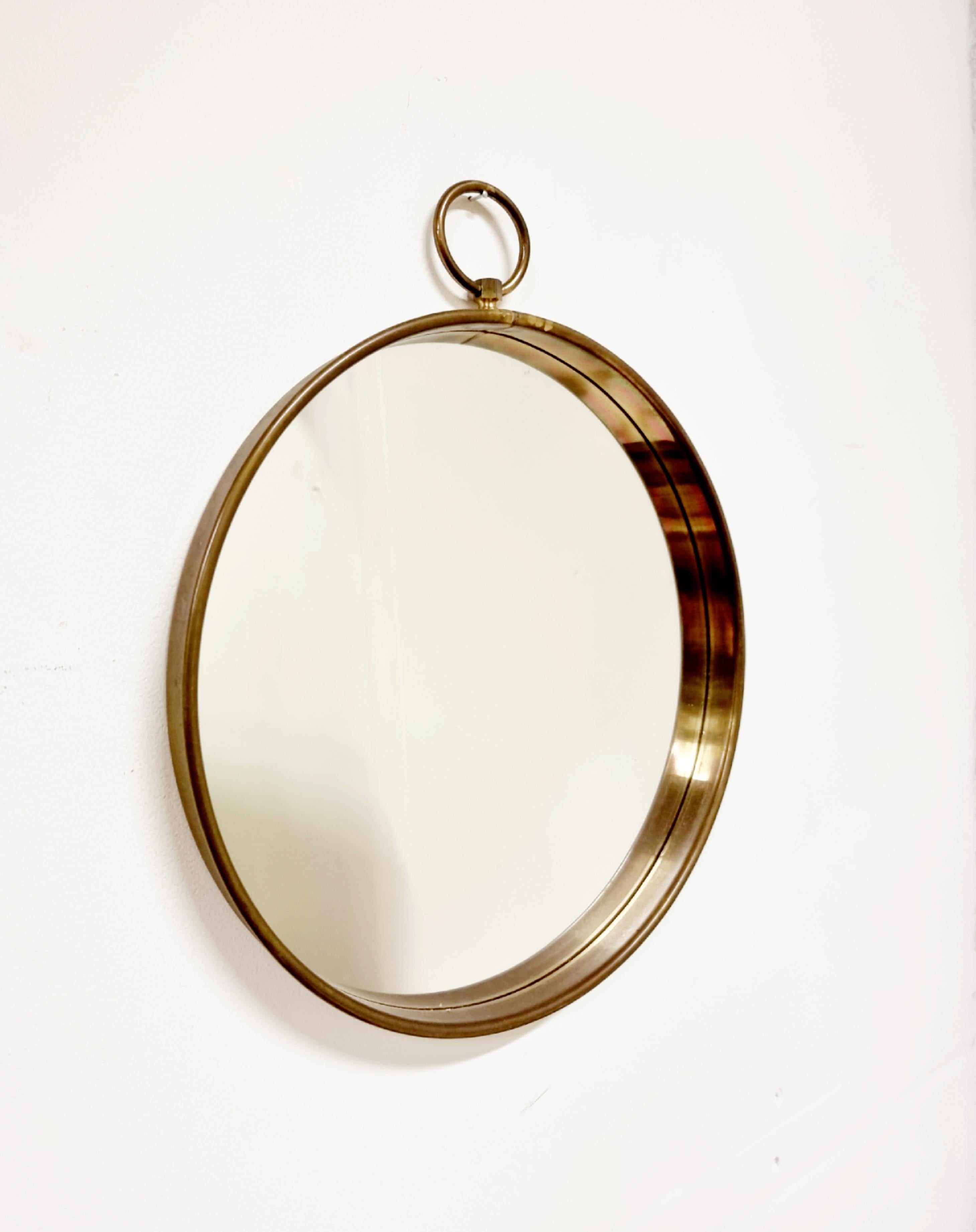 Pocketwatch shaped mirror with brass frame. Italian, Midcentury. 

With beautiful patina which shows the age. 

Please feel free to contact us regarding additional photos or information.