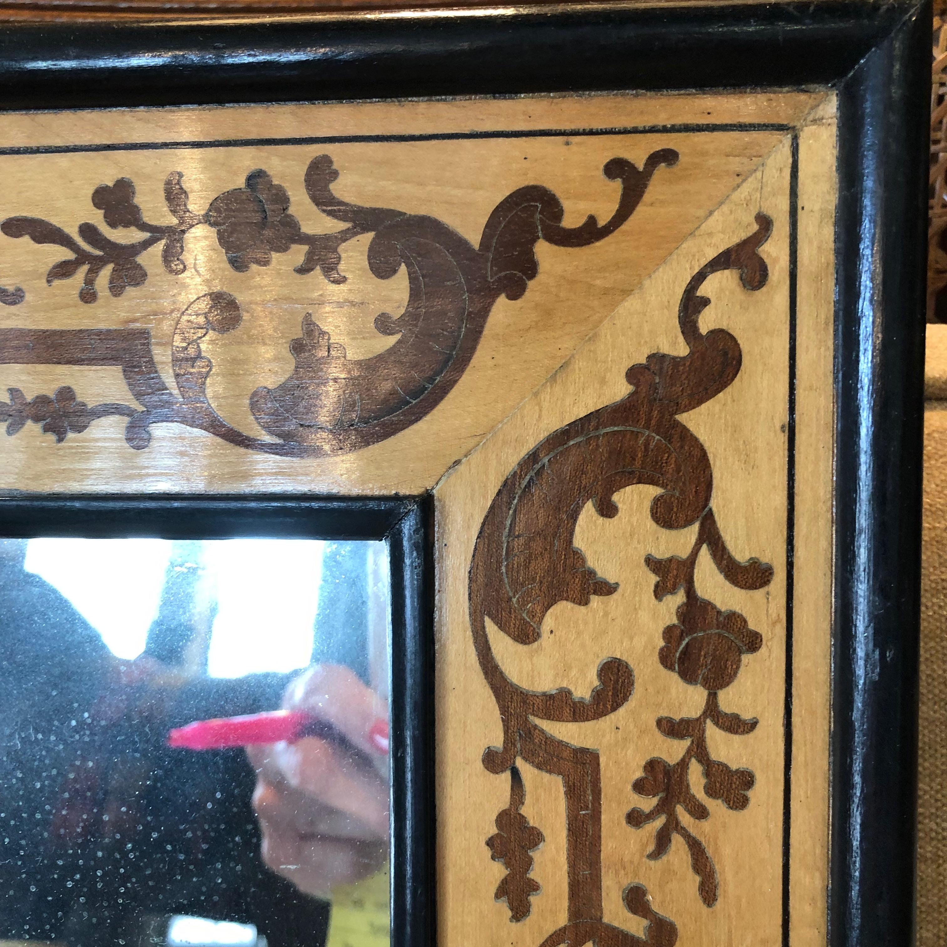 This small mirror with inlaid design is early 1900s handmade.