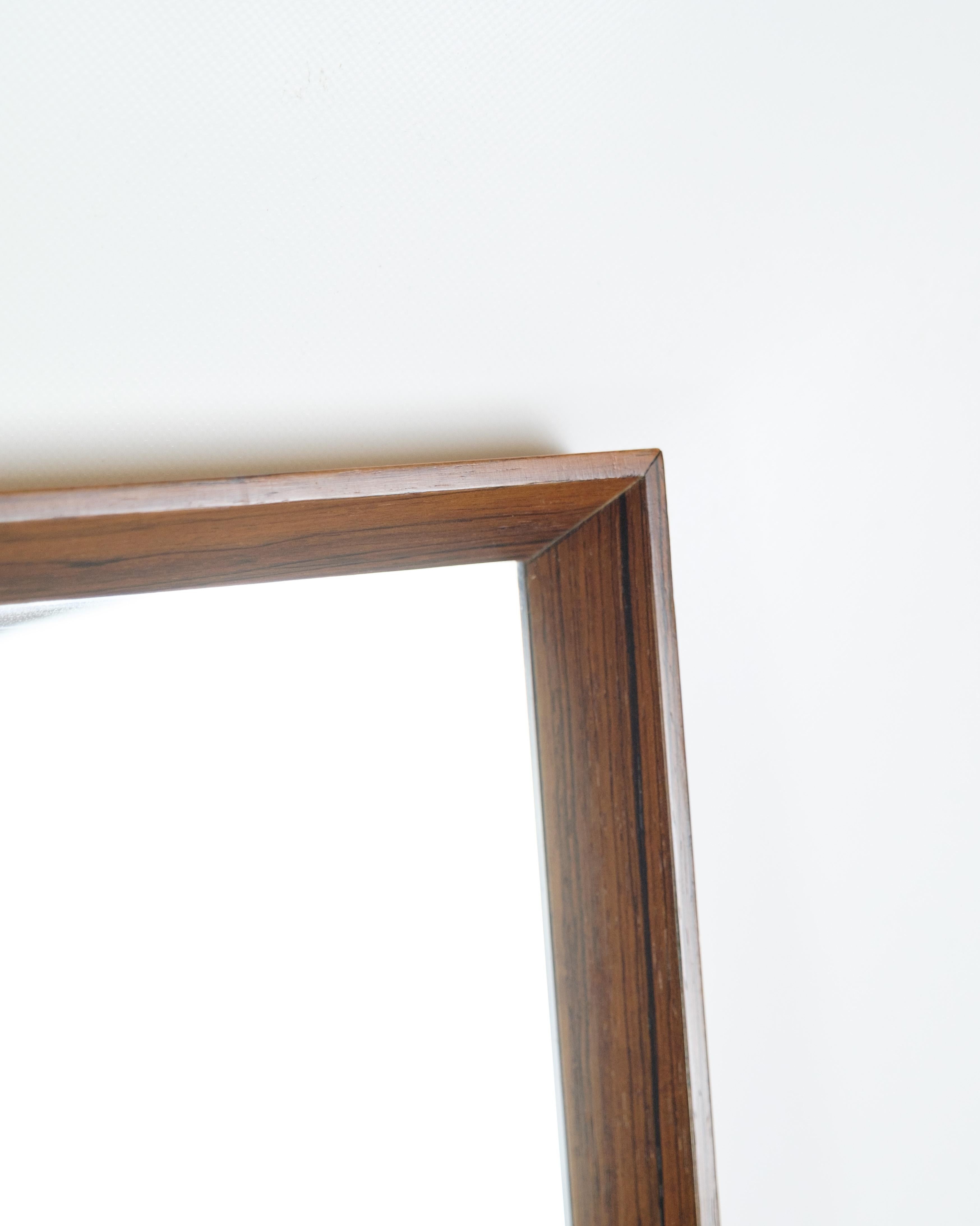 Mirror made with a rosewood frame, Danish design from the 1960s.

The mirror is in very good condition and will be checked at the workshop before delivery.

Dimensions: H:106cm W:45cm