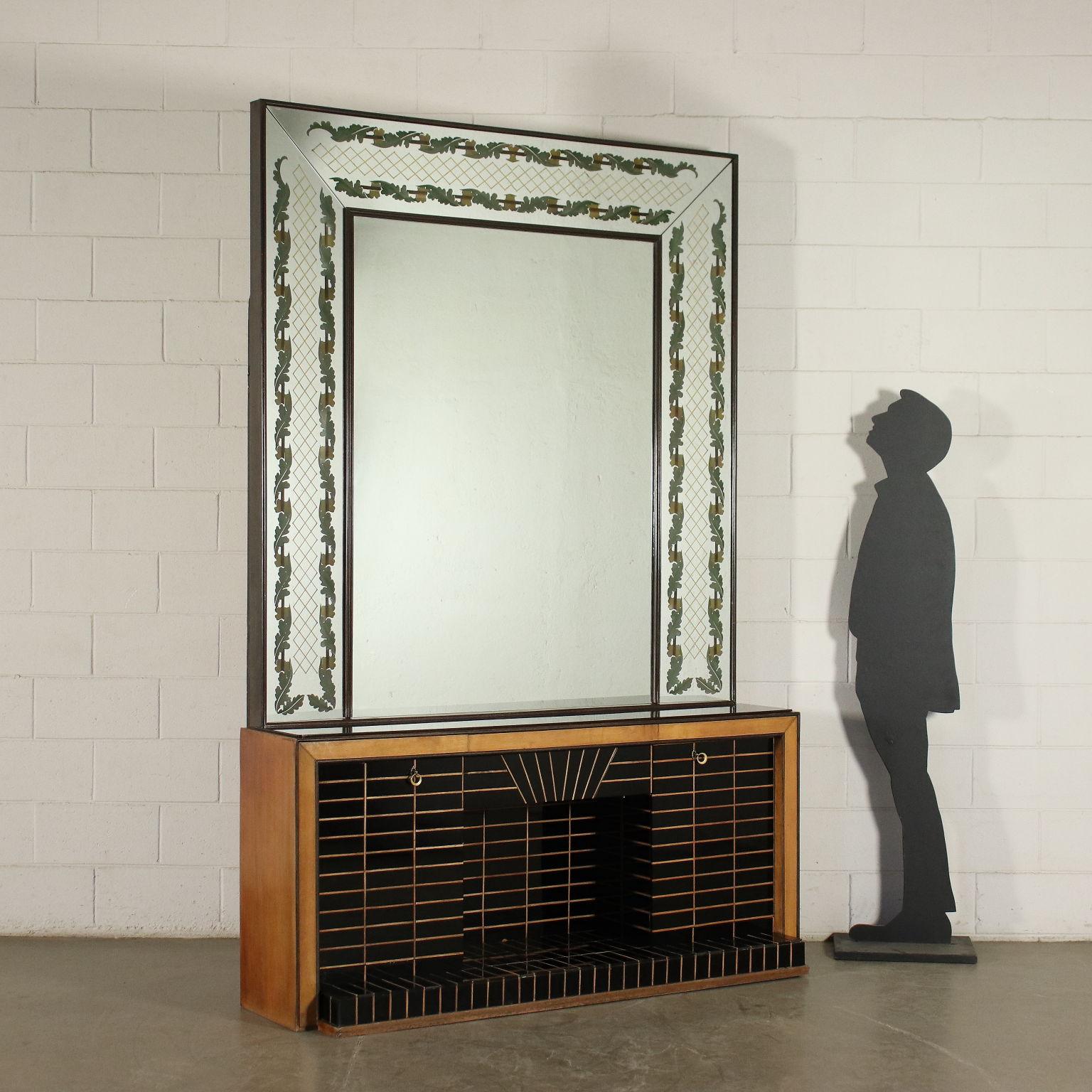 Large mirror in the style of Brusotti, mounted on a fake fireplace, back-lit mirror with a gilded frame, fireplace with hinged doors, wood covered with tiles in opaline glass, interiors with mirrored glass tiles.