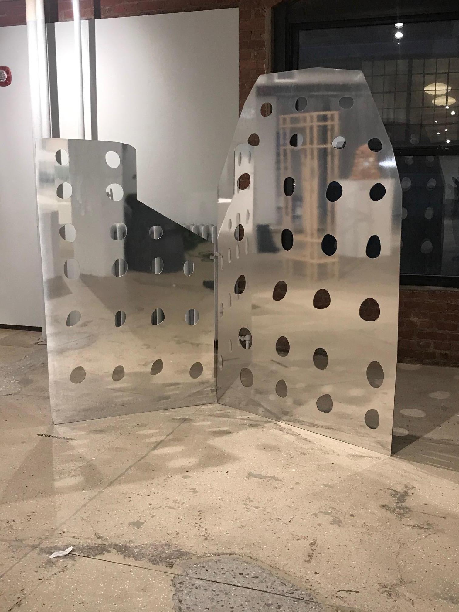 By using pastel sketches as construction drawings a series of mirrored aluminum screens  are created from the recollection of buildings and areas of endearment. A feeling of nostalgia is created as the childlike drawings are enlarged and taken off