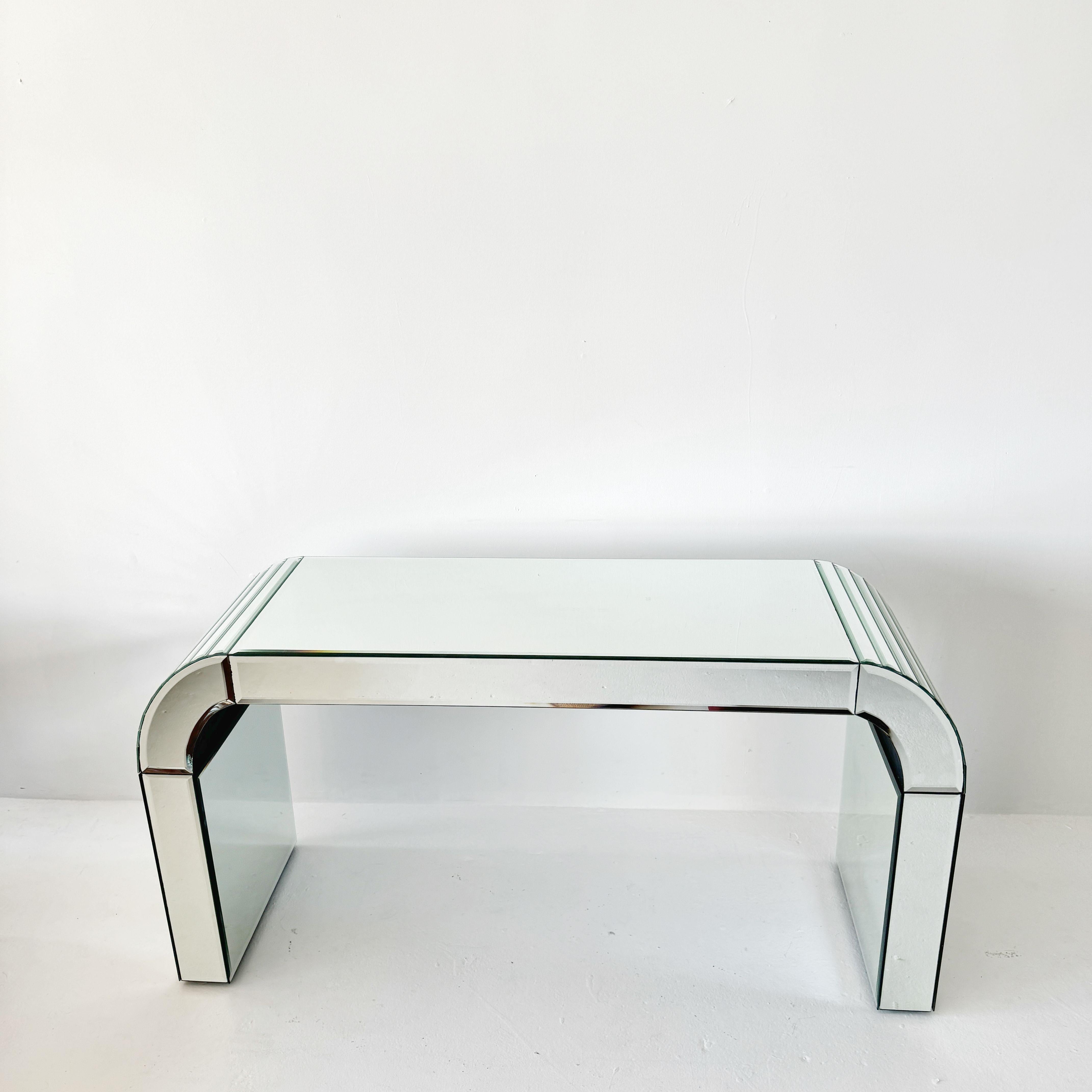 mirrored art deco waterfall console table or writing desk with one drawer. The handle for the drawer can easily be removed (or changed) if you prefer to see it without a drawer or handle (the back side, pictured, is all mirror)

L59.5 H31.5