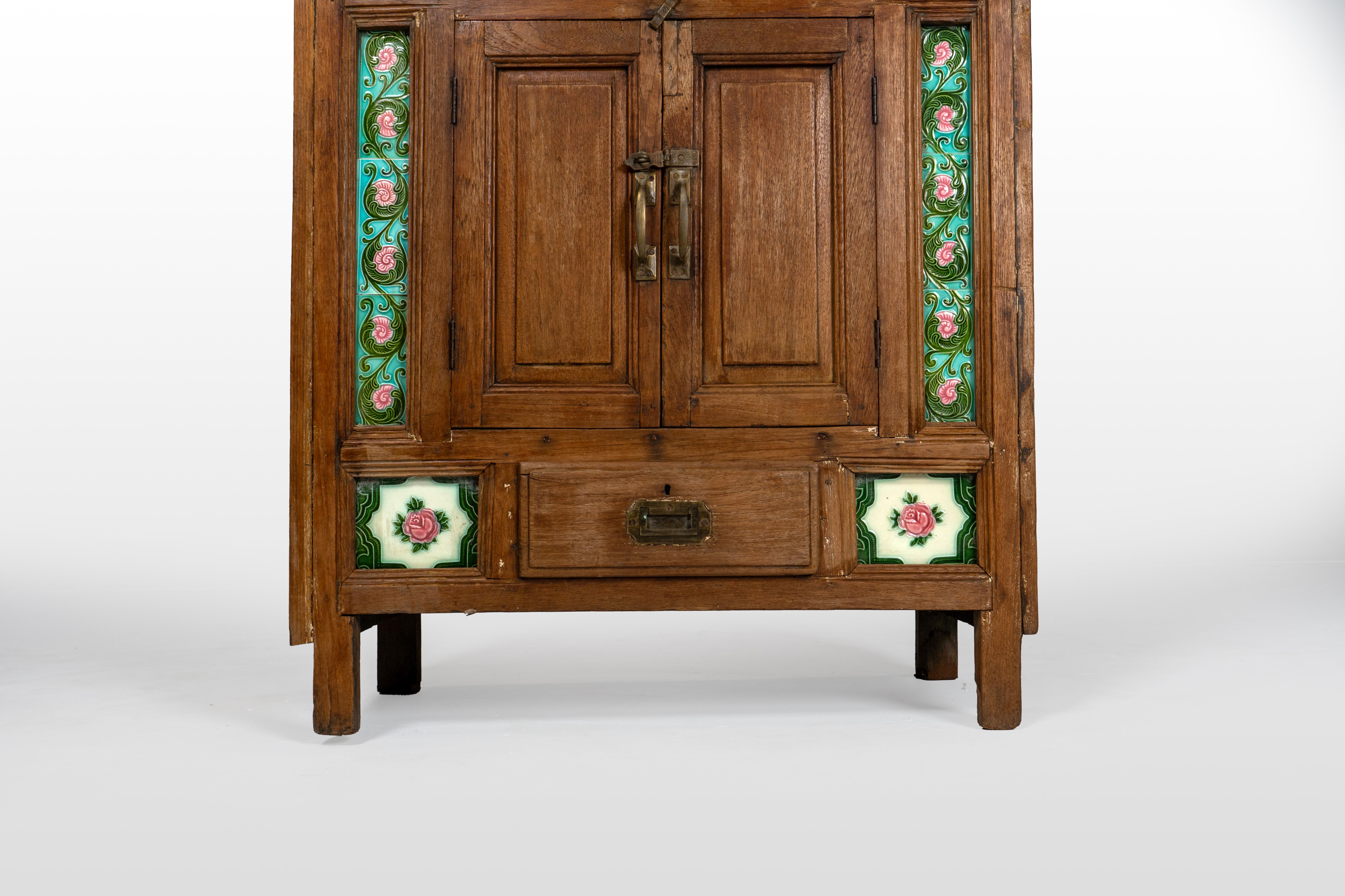 20th Century A British Colonial Cabinet with Green Decorative Floral Tiles