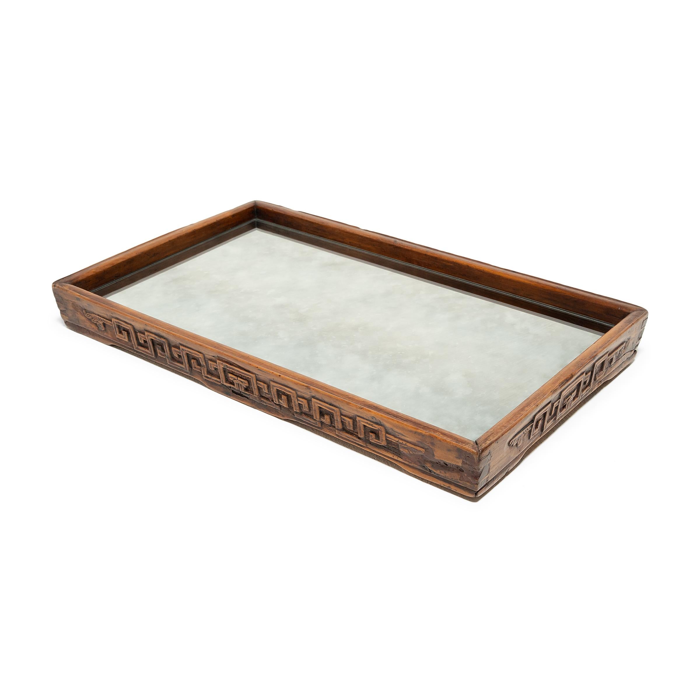 Dovetail joinery and carved geometric scrollwork add charming detail to the simple lines of this century-old provincial tray. The rectangular tray has developed great character from years of serving tea, likely for friends and family gathered on