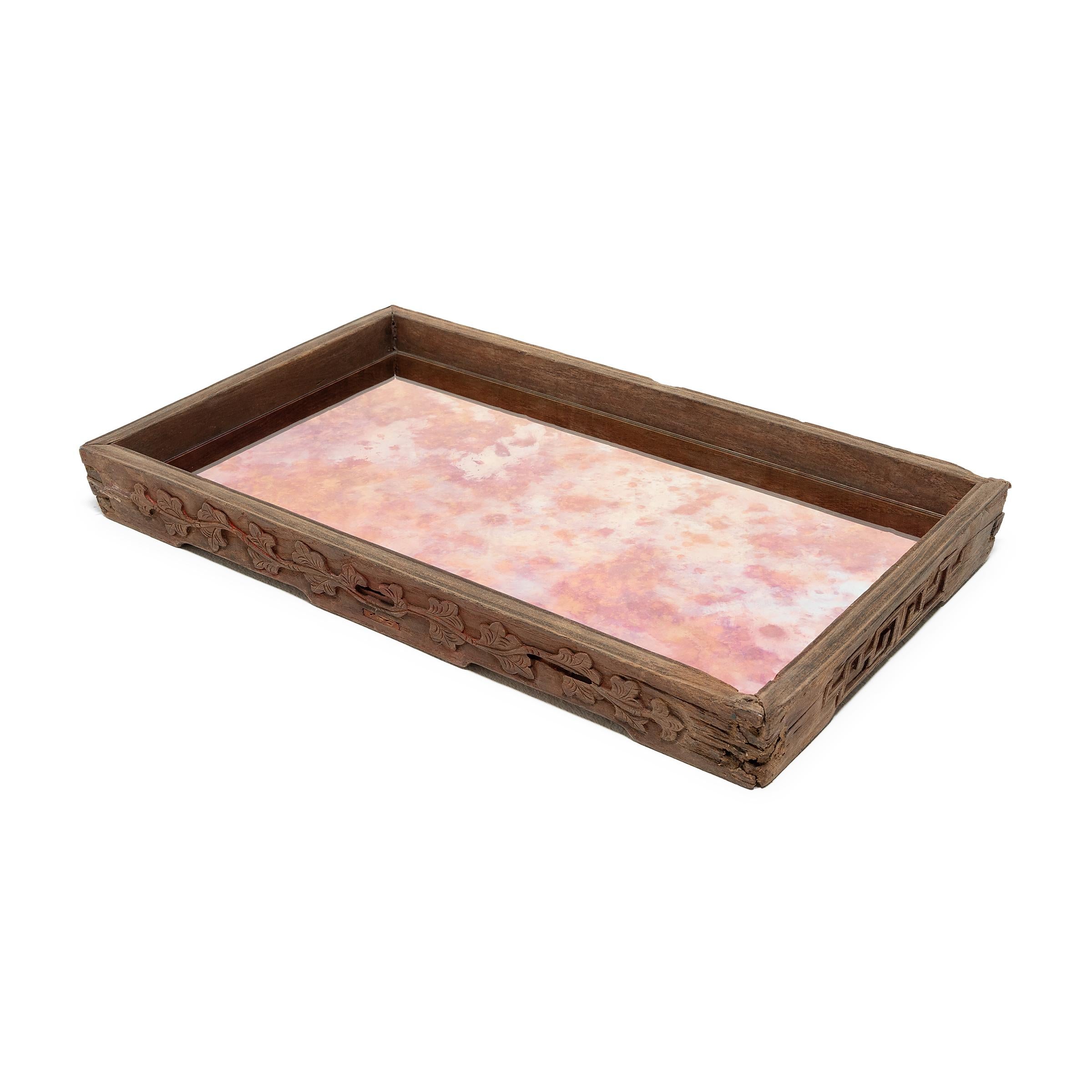 Dovetail joinery and carved floral scrollwork add charming detail to the simple lines of this century-old provincial tray. The rectangular tray has developed great character from years of serving tea, likely for friends and family gathered on