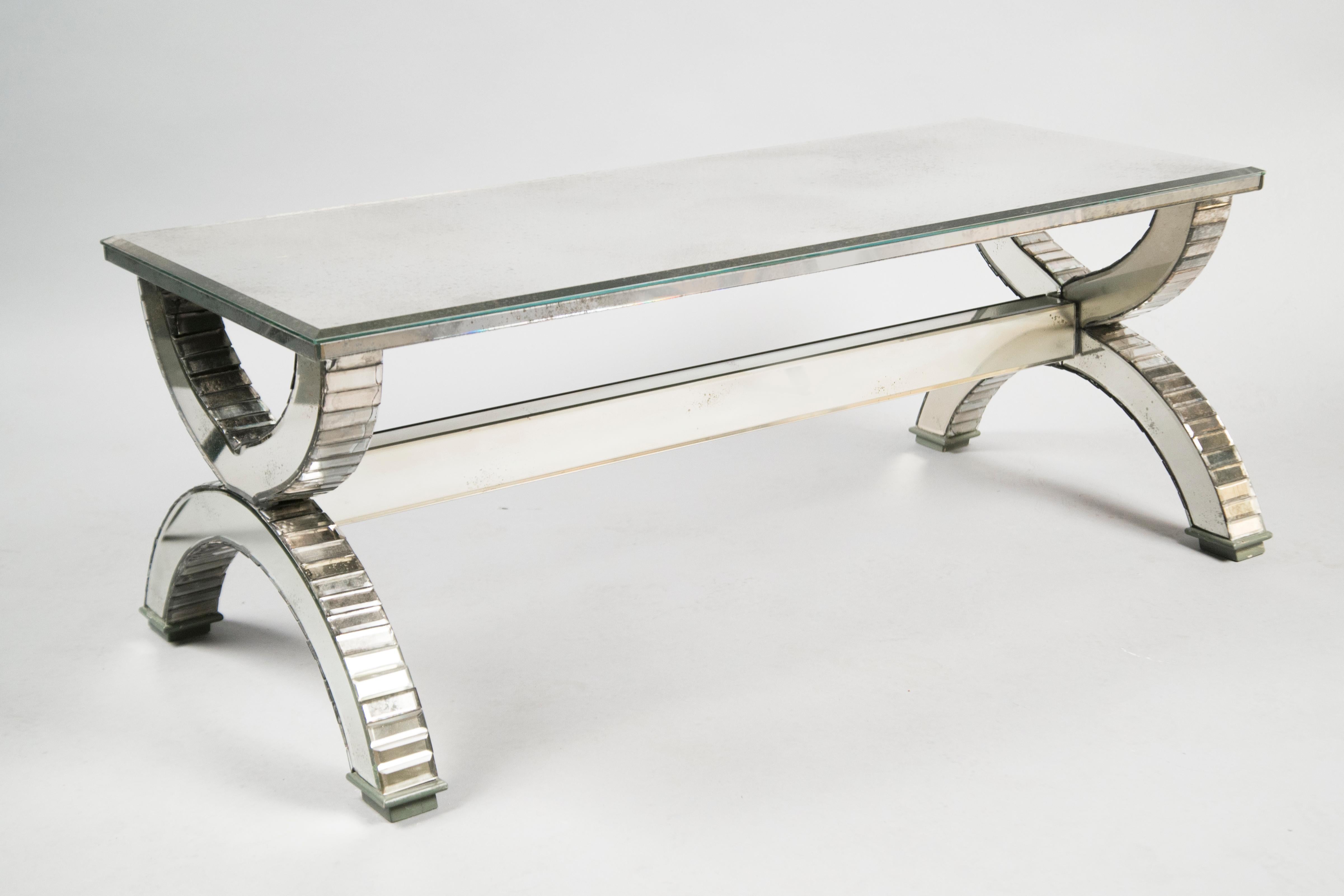 Each table featuring mirror-clad curule-form sides, joined by a long mirrored stretcher, supporting a newly fabricated (slightly aged) mirror top with beveled edges. 
 
