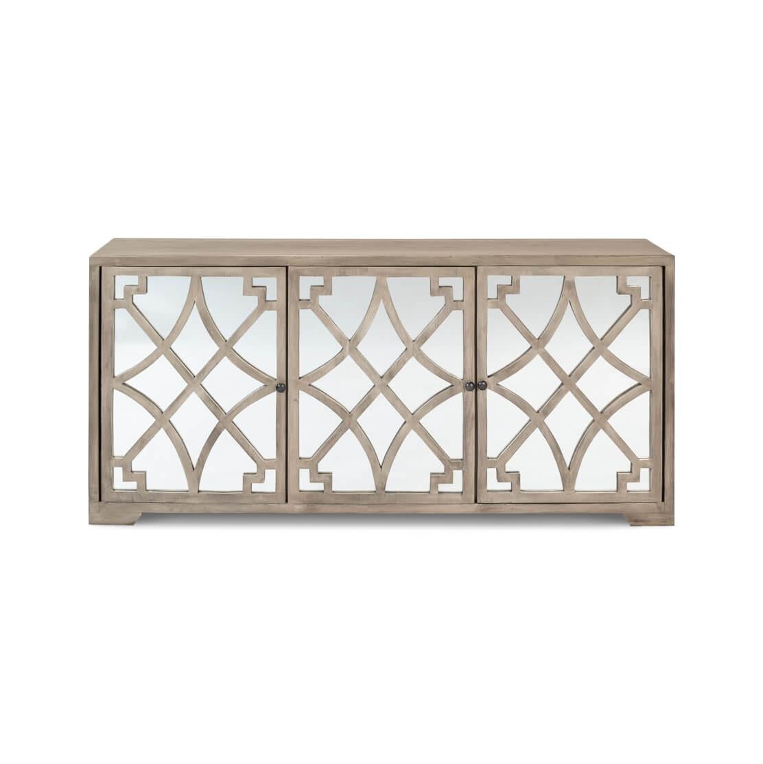 The eye is drawn to the symmetrical lattice woodwork on the mirrored doors, a feature that amplifies light and adds depth to any room.

The natural wood finish lends a grounded, earthy feel to the piece, providing a beautiful contrast to the