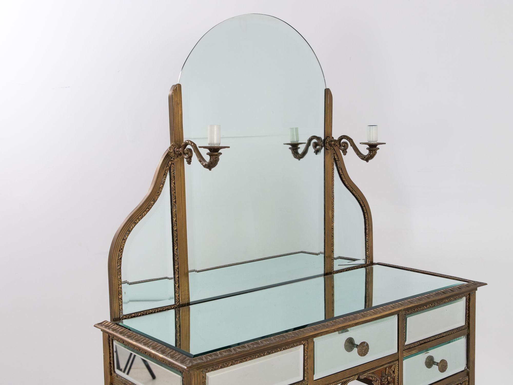 Vintage French 1940s mirrored glass dressing table or vanity with two electrified sconces. Needs to be rewired. Three working drawers. Good condition except a couple of decorative rosettes are missing. Desk height is 32