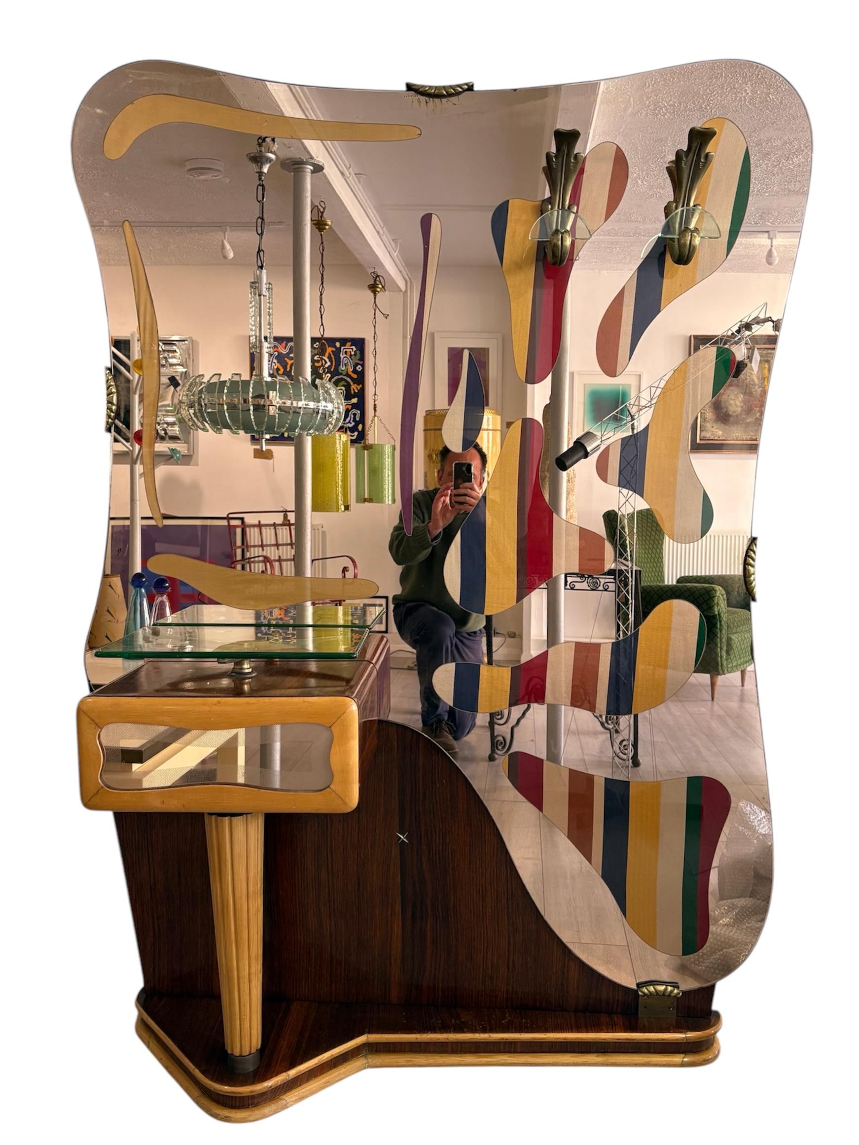 This is a truly sensational Italian floor standing 1930s mirror. Mirror and glass, behind the organic shaped glass elements is the most beautiful striped silk , exquisitely and effortlessly stylish in a very sophisticated Italian manner.

The two