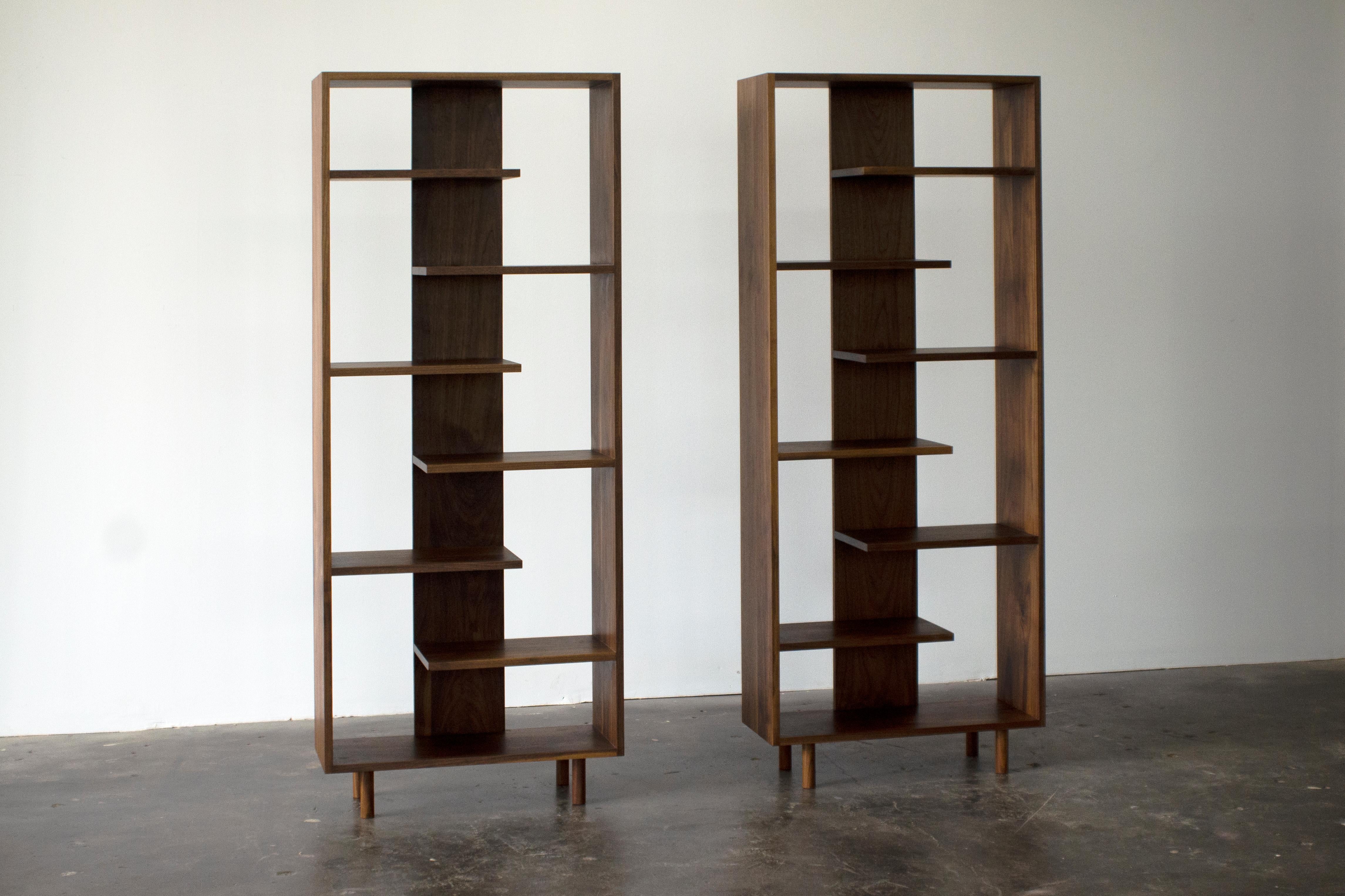 Paso shelving was designed to embody simplicity and harmony through the use of rhythmical geometries and warm natural materials. Alternating ladder-like shelves create discrete sections which are ideal for displaying favorite books and objects. This