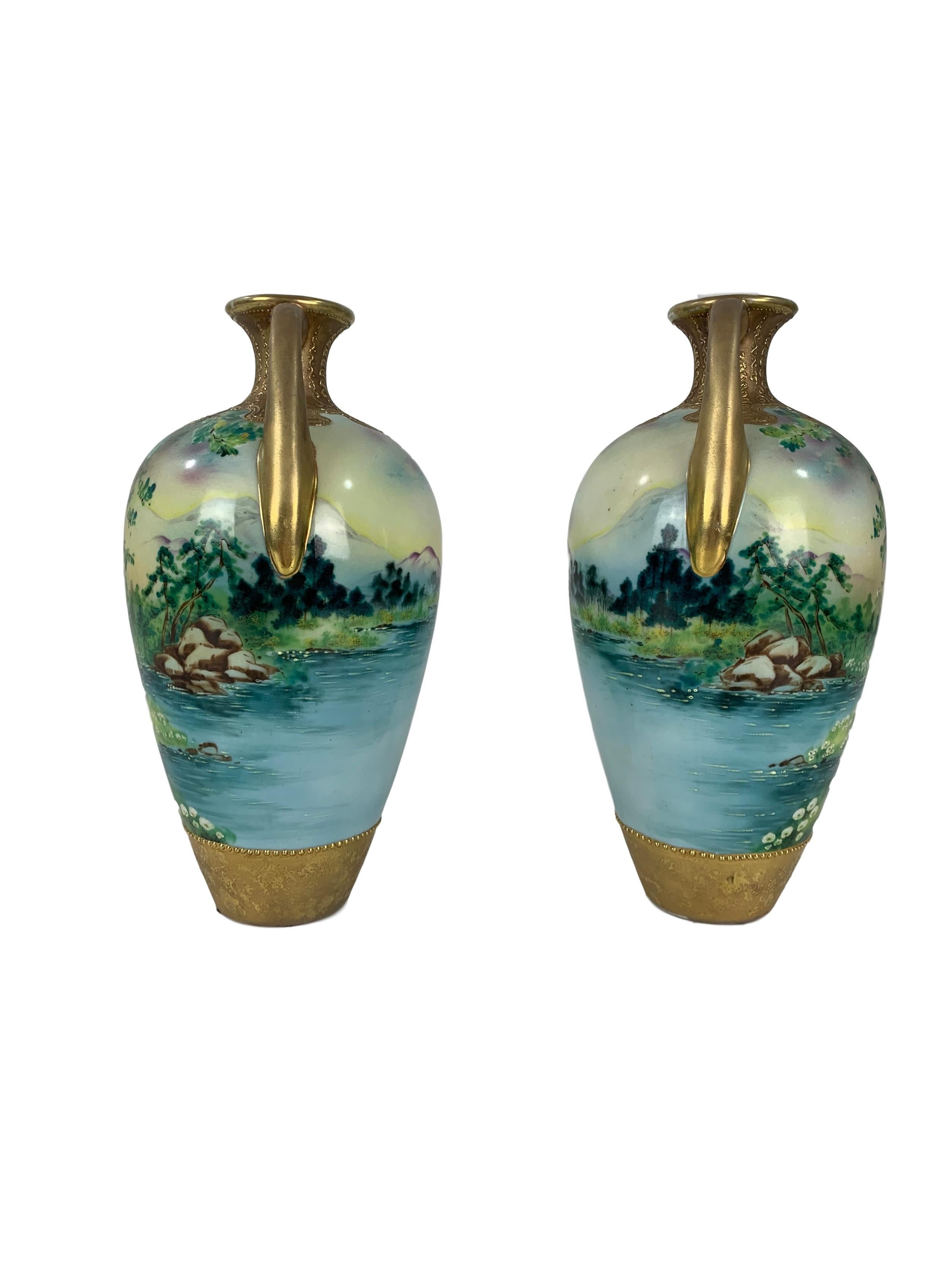 Pair of hand painted Antique Nippon mirrored vases, made for export to the West, Japan 1890 to 1920. Painted with forest mountain lake scenes.

2
