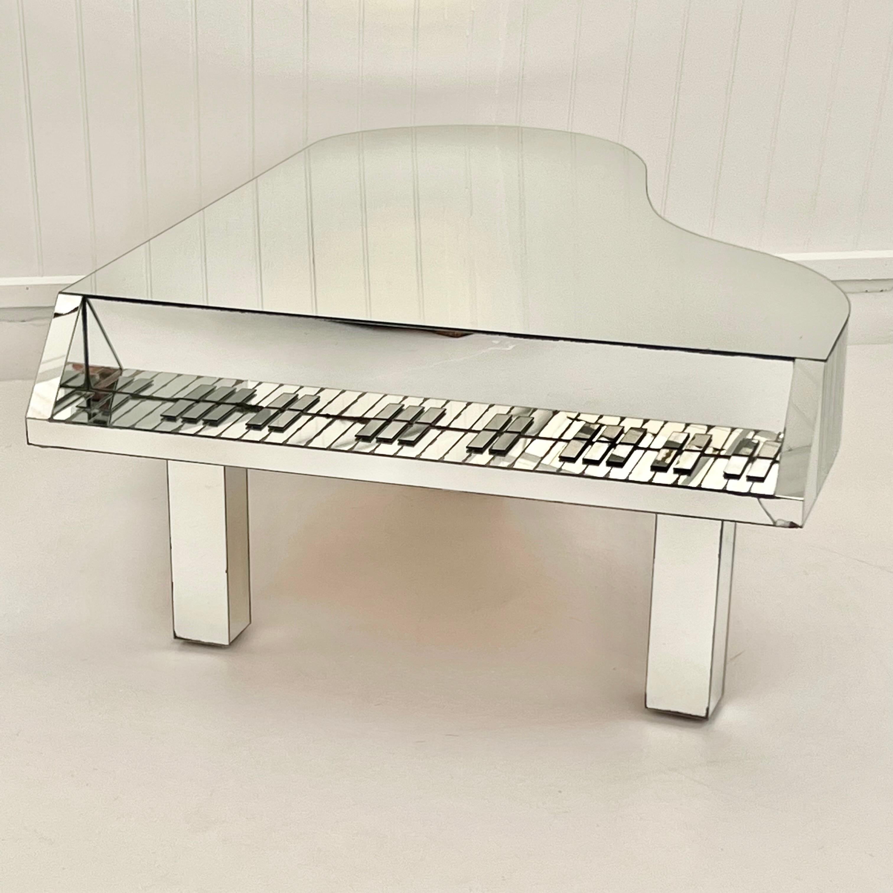Wonderfully eccentric, piano-shaped coffee or cocktail table, made of mirrored glass, circa 1970s. Adds a touch of pop-art, opulence and eccentricity to any home interior. 

One single sheet of glass makes up the top while the sides and keys are
