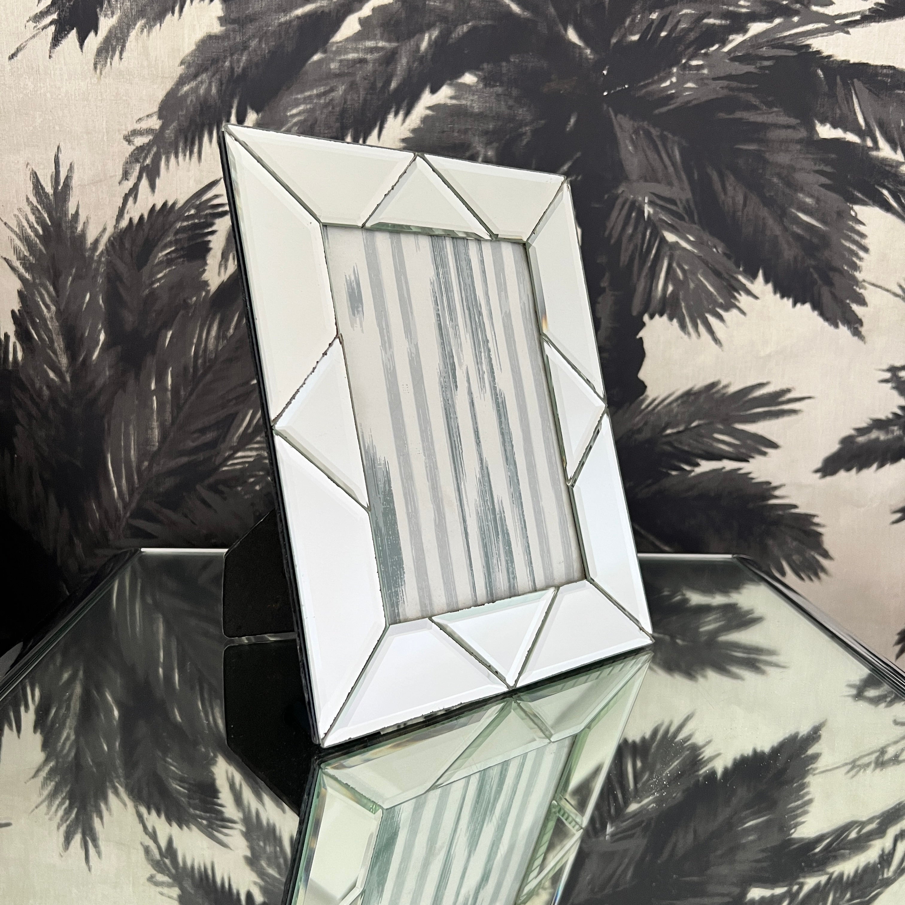 1980s Italian glass photo frame with geometric design comprised of hand beveled mirrored glass. The frames measures 10