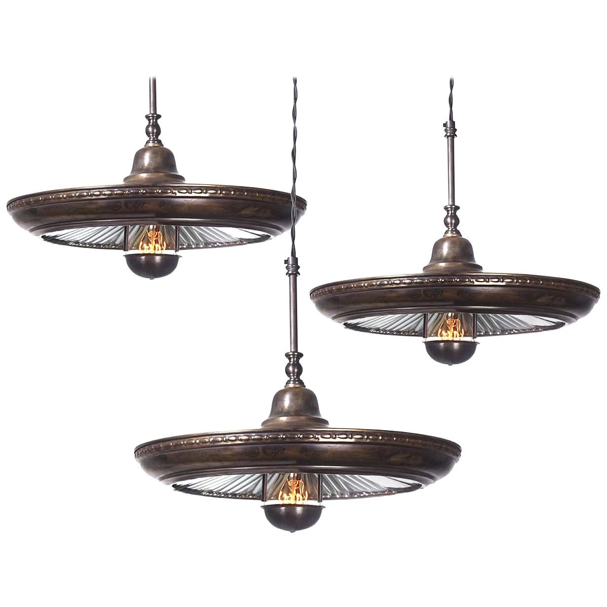 We have a nice collection of these Classic mirrored ring pendants. In addition to the fluted mirror there are some subtle decorative details that make this one stand out. The most interesting feature is the bulb cover with three springs and a hole