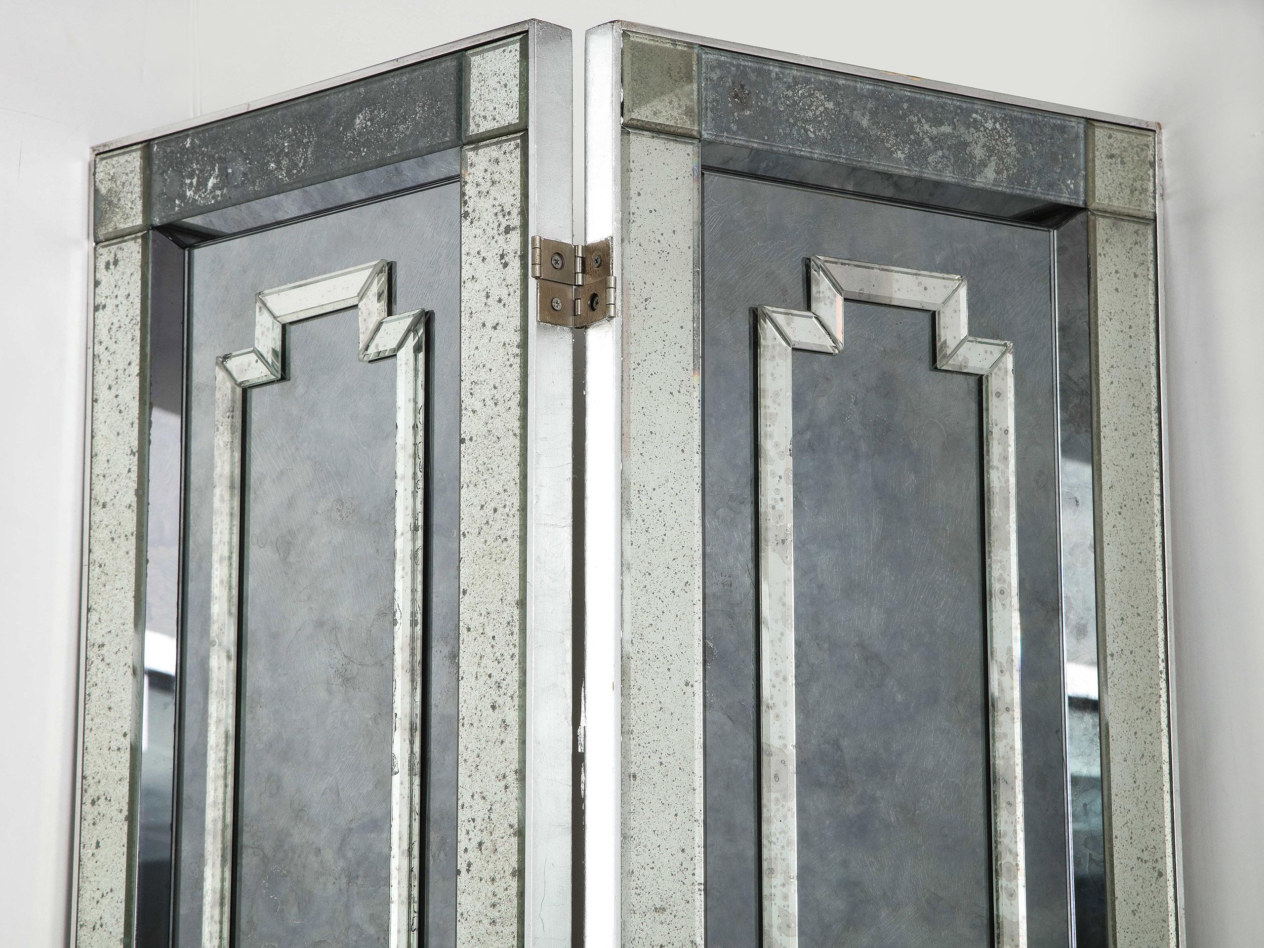 Midcentury 8-panel antiqued mirror screen

Each panel having a neoclassical design of intricately layered mirror appliqués on top of the mirrored base panel. The back painted gray

Each panel @15