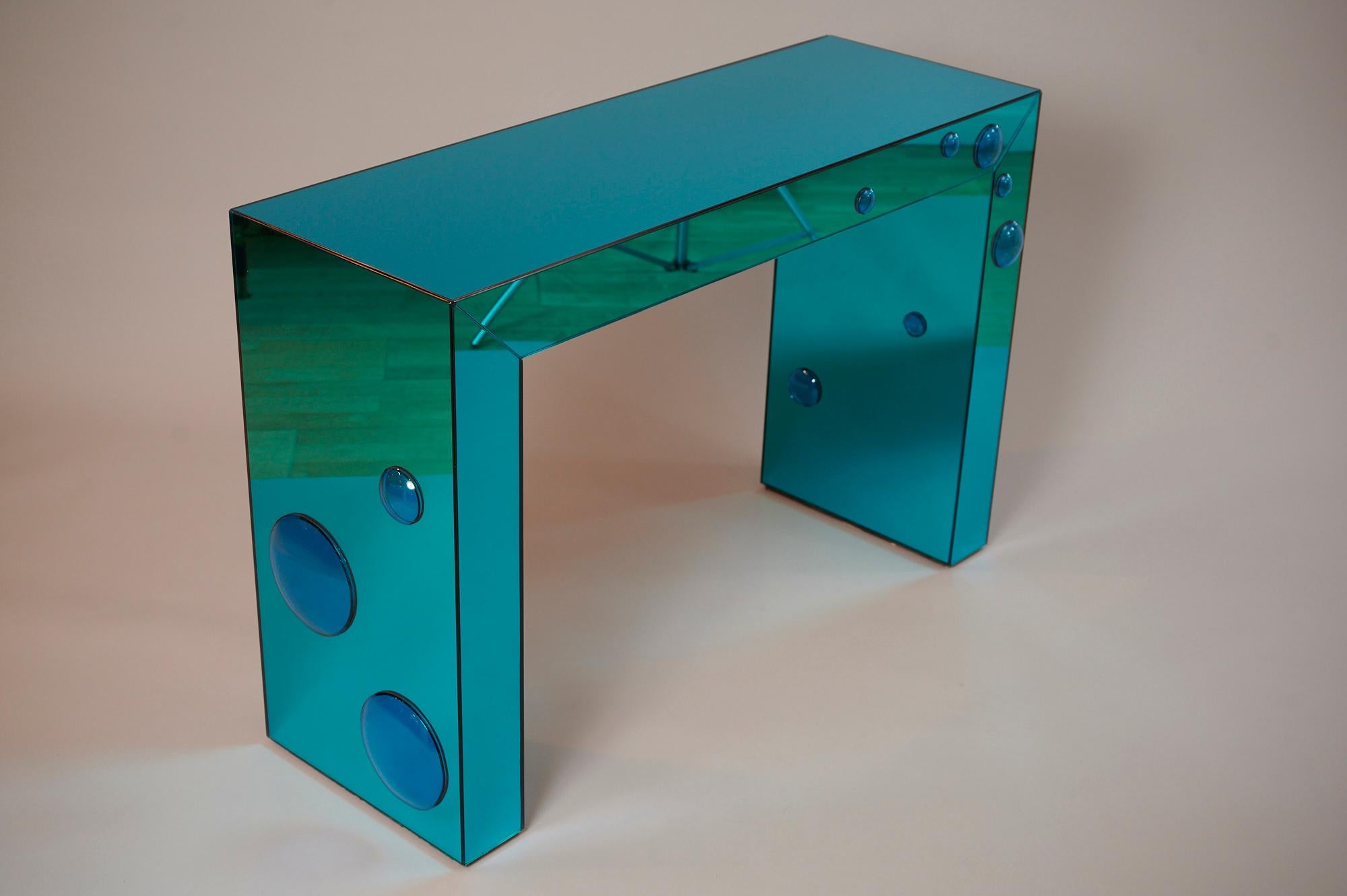 Unique consoles in mirrored 'seagreen' glass with blue glass bubble spots

Available in different colour combinations. And sizes...

Please enquire 

Also, available with matching concave mirrors.. Bespoke sizes.