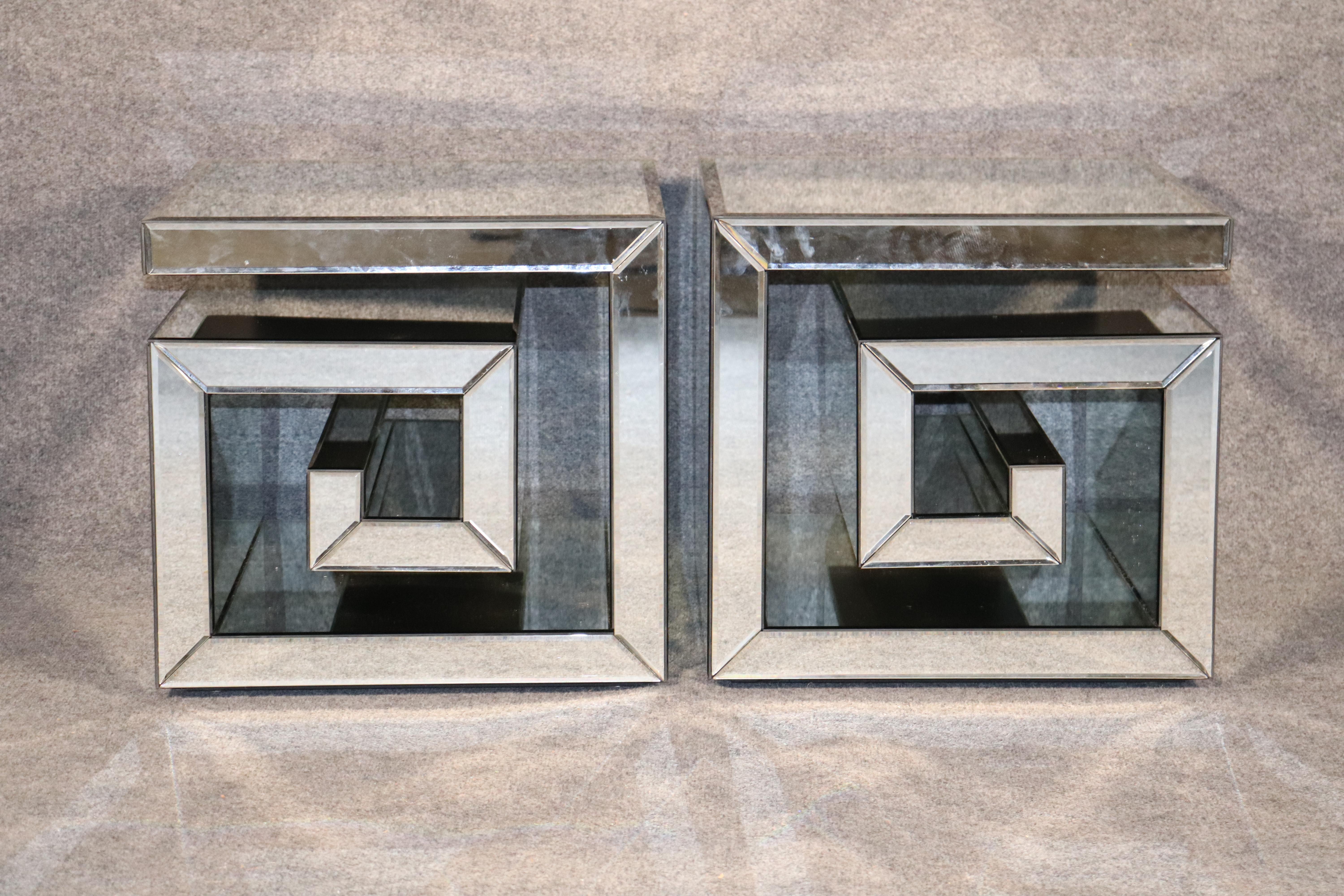 Pair of mirrored stands with spiral Greek key style form. Made with beveled mirrored glass.
Please confirm location.