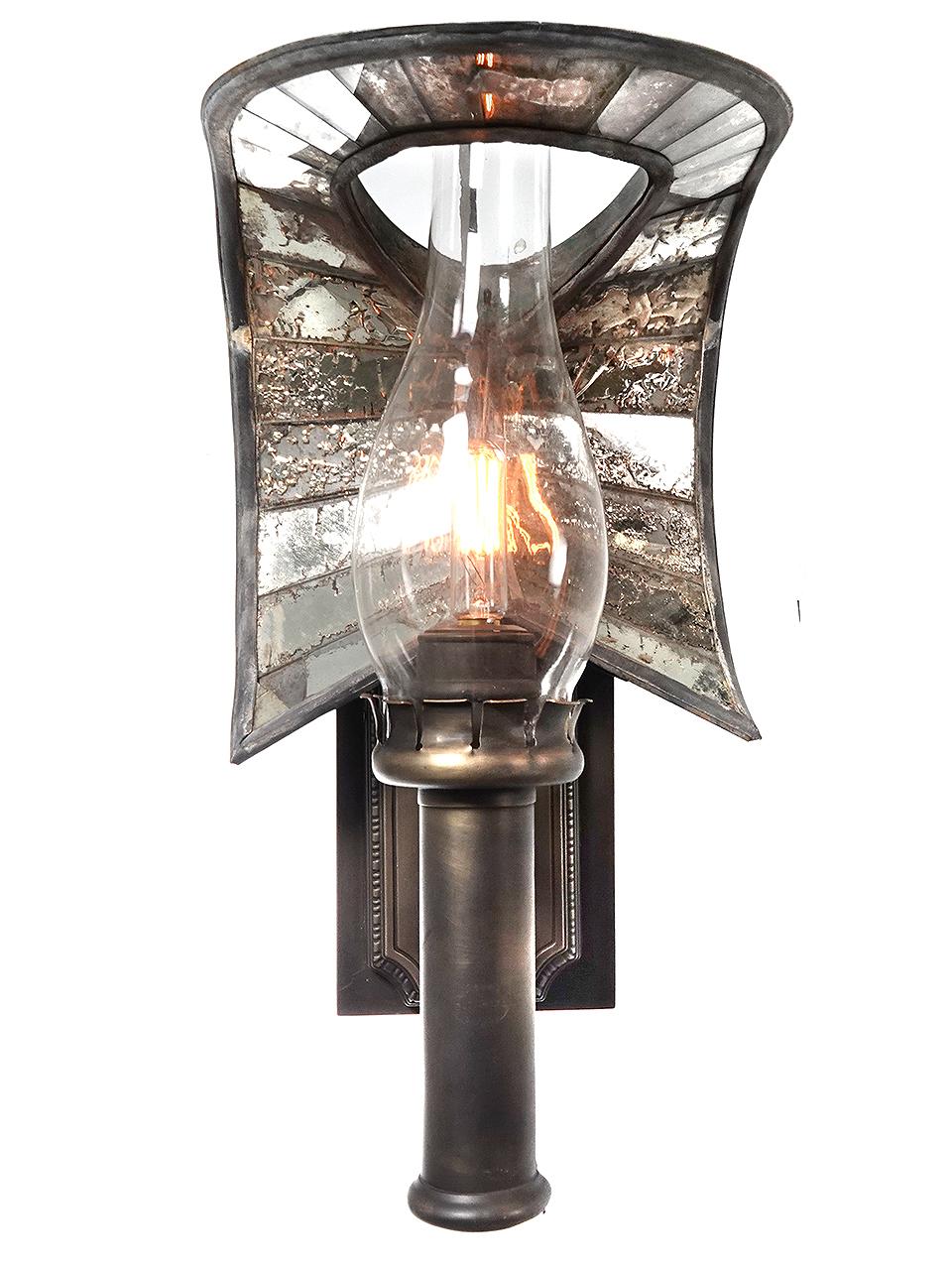 This is an amazing sconce. The lamp is signed Adams and Westlake and it features a rare mirrored reflector. The whale tail reflector is also signed and was made by Wheeler. The mirrors are all original with the original rustic patina. Note that one