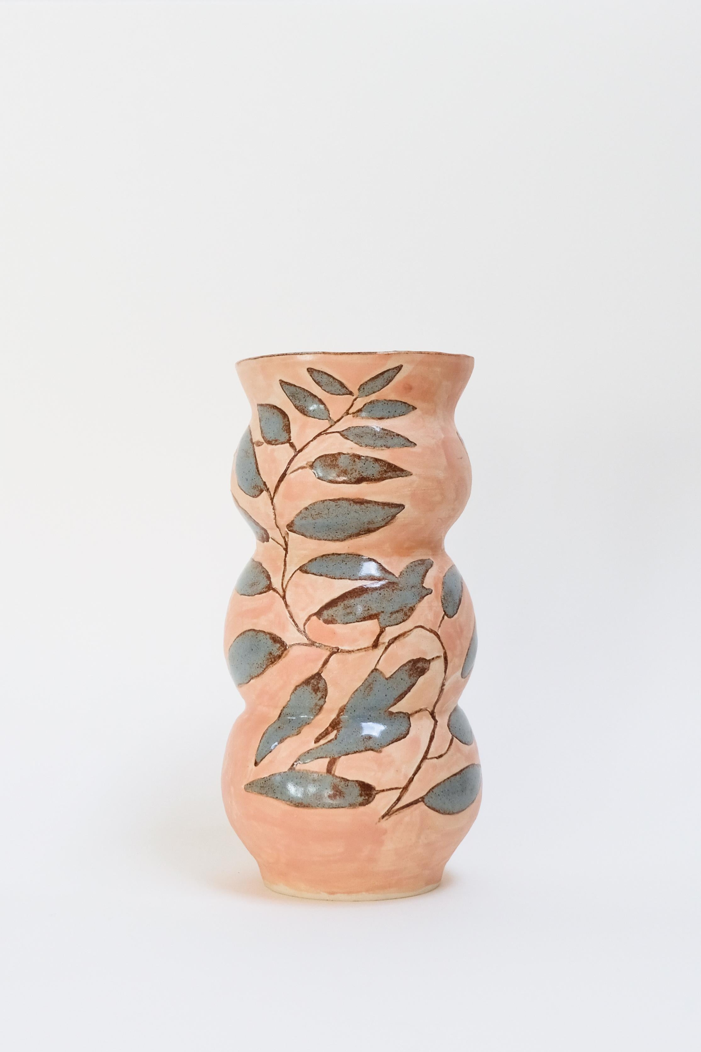 This warm contemporary botanical ceramic vase features a unique bird design and is an original artwork by Canadian artist Misbah Ahmed. This piece from her collection of Mur vessels explores organic feminine forms with clay. Mur - meaning curve -