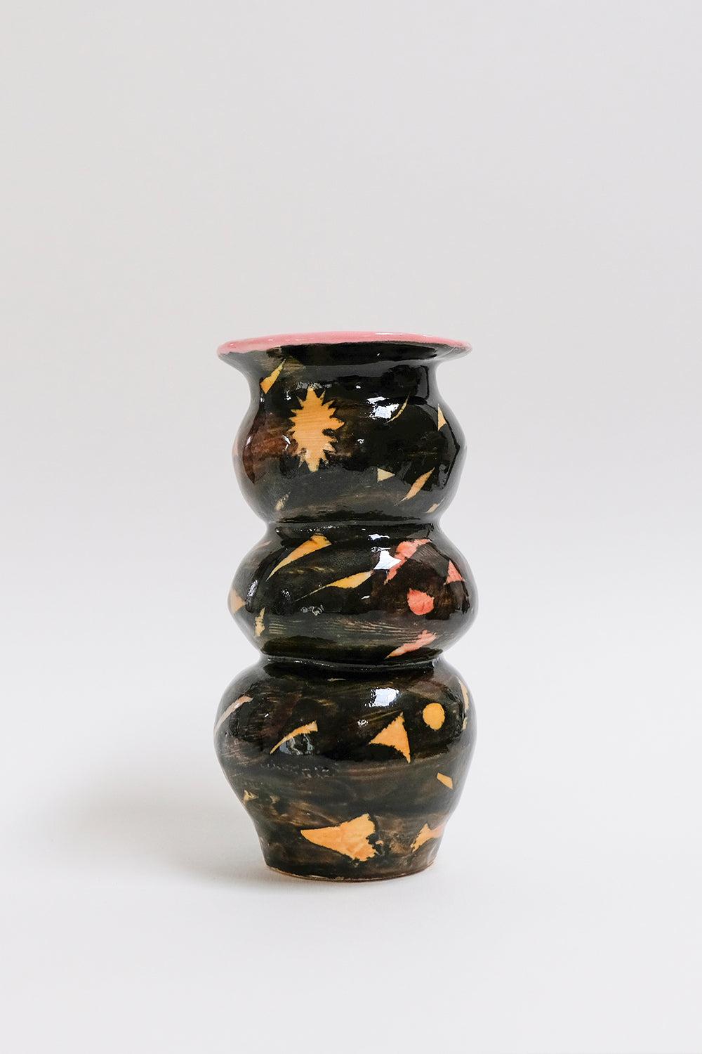 This contemporary black and bright pink ceramic vase features a geometric surface pattern and is an original artwork by Canadian artist Misbah Ahmed. This piece from her collection of Mur vessels explores organic feminine forms with clay. Mur -