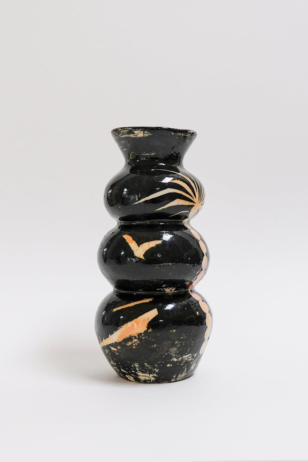 This contemporary black and peach ceramic vase is an original artwork by Canadian artist Misbah Ahmed. This piece from her collection of Mur vessels explores organic feminine forms with clay. Mur - meaning curve - uses a combination of wheel