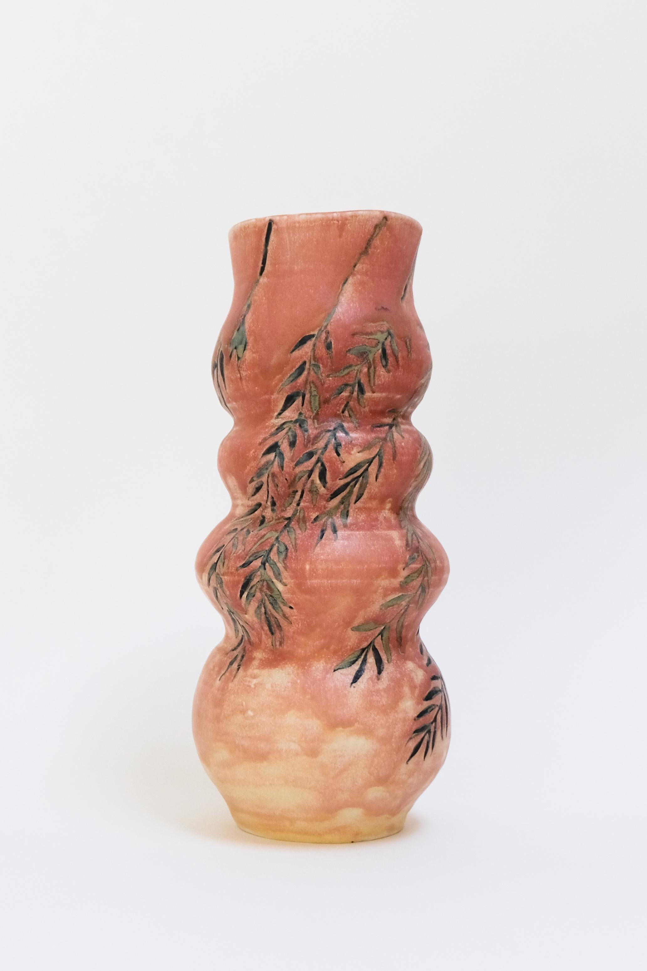 This warm pink contemporary botanical ceramic vase features a unique willow branch design and is an original artwork by Canadian artist Misbah Ahmed. This piece from her collection of Mur vessels explores organic feminine forms with clay. Mur -