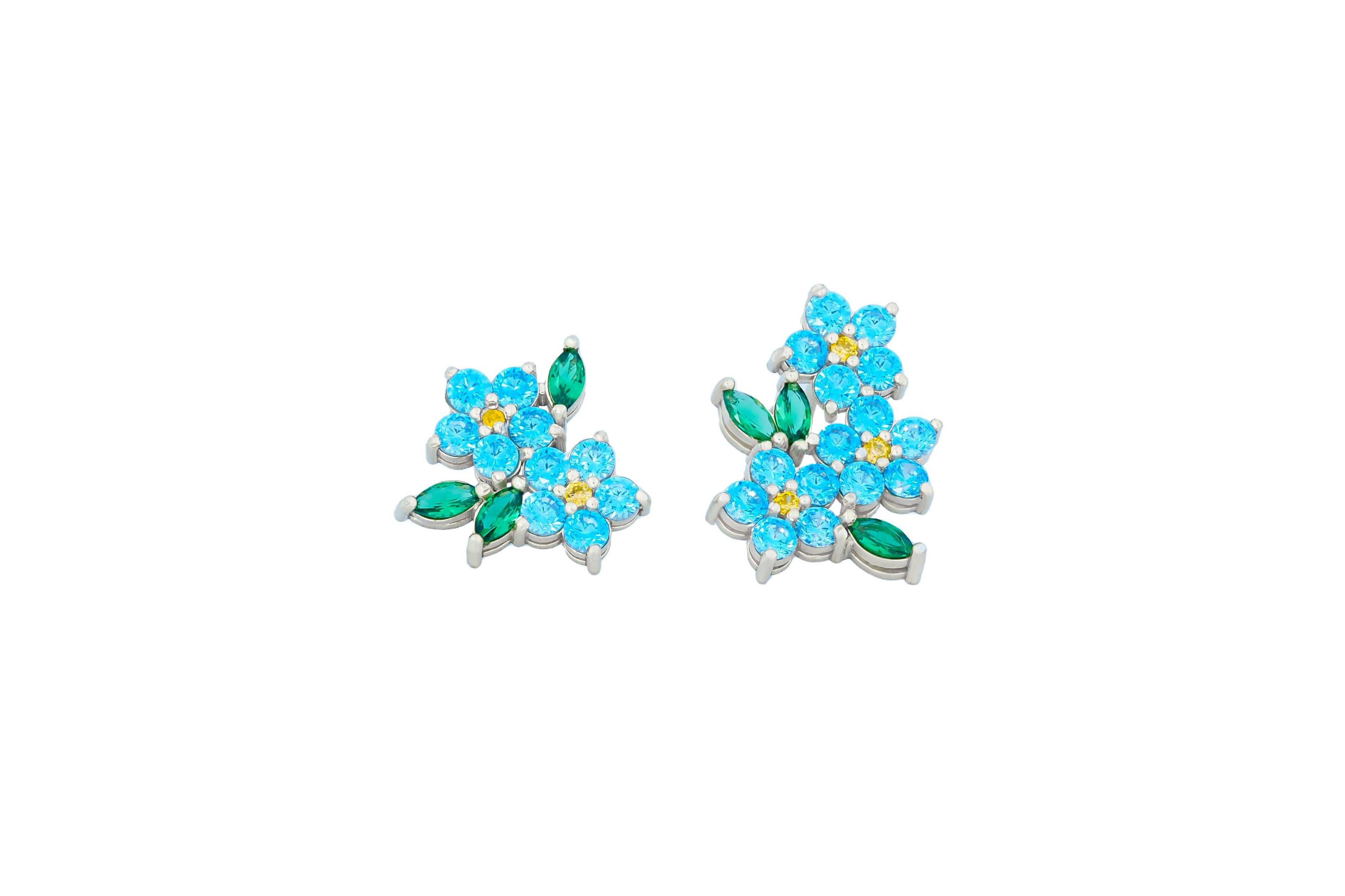 Modern Mismatched flower earrings with colored gemstones in 14k gold. For Sale
