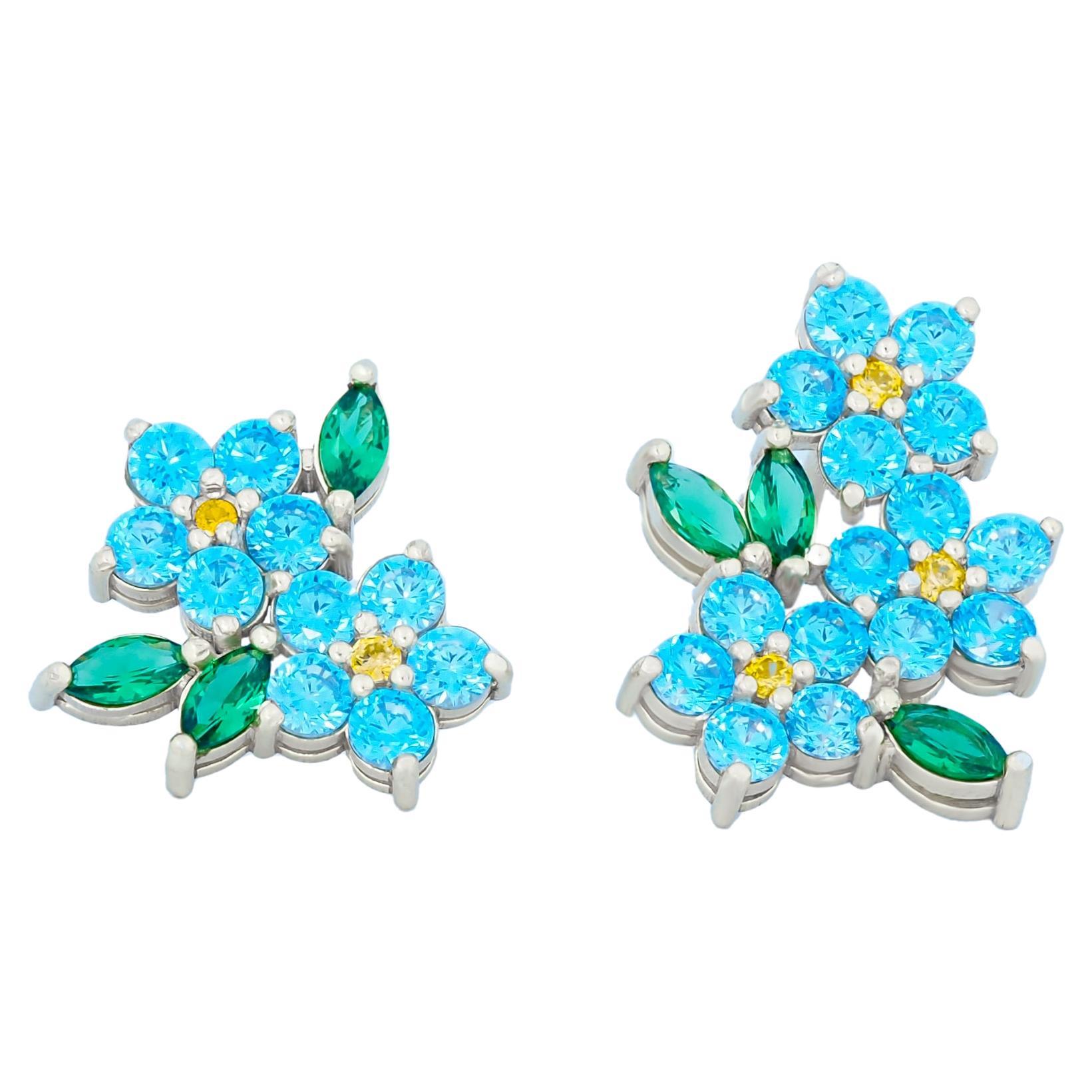 Mismatched flower earrings with colored gemstones in 14k gold. For Sale