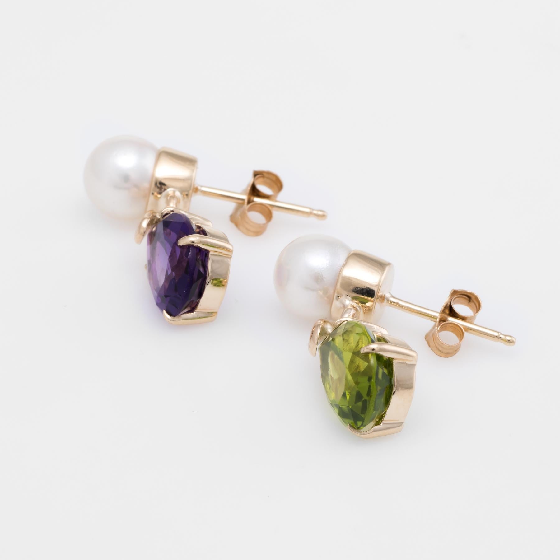 Elegant pair of gemstone drop earrings, crafted in 14k yellow gold. 

Faceted pear cut amethyst and peridot measures 10mm x 8mm (estimated at 2.50 carats each), accented with 2 x 7mm cultured pearls. The gemstones are in excellent condition and free