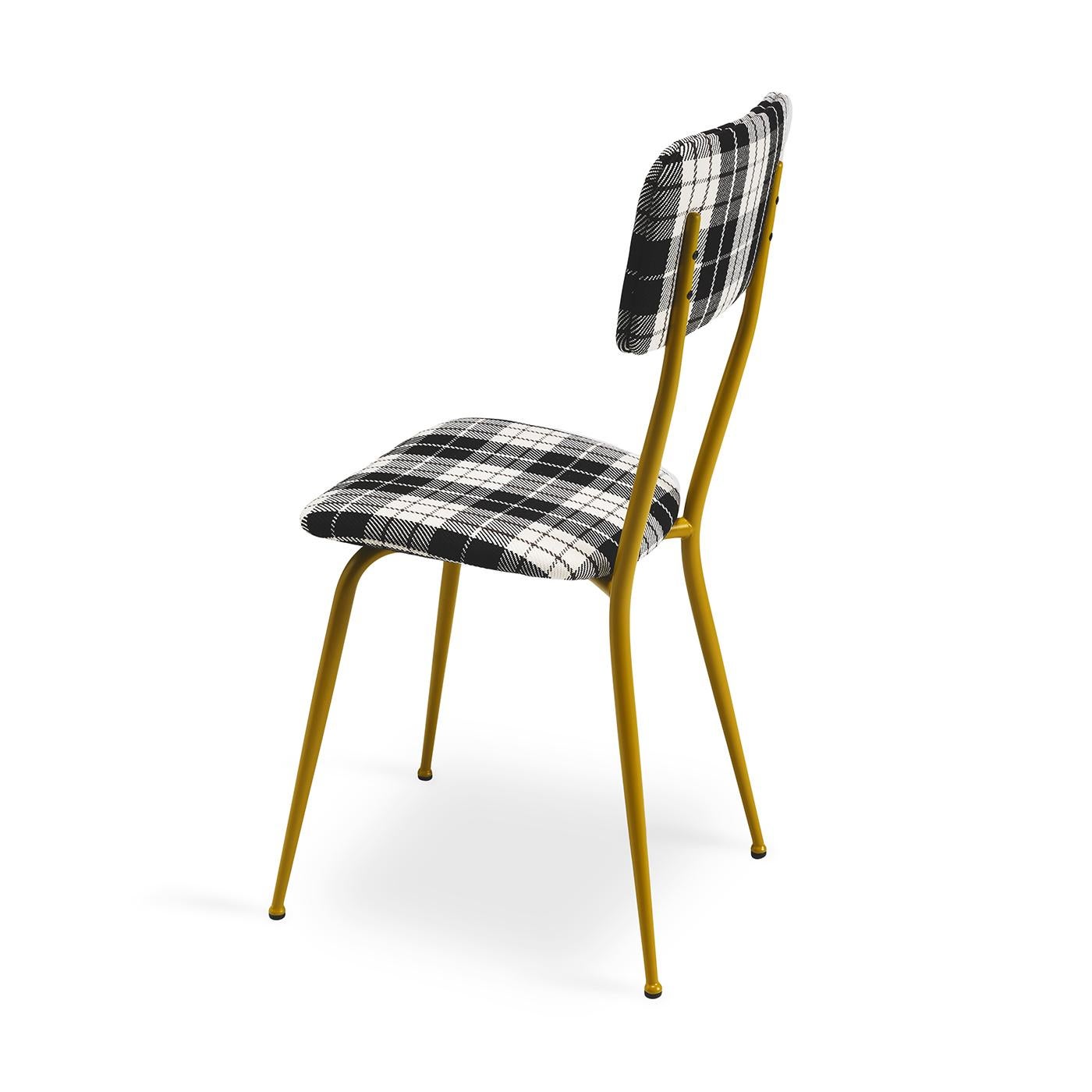 The Miss Ava 1 chair exudes an understated elegance with its sleek metal frame, boasting a matte tobacco lacquered finish that complements a variety of interior styles. Upholstered in elegant tartan fabric, this piece succeeds in fusing modern