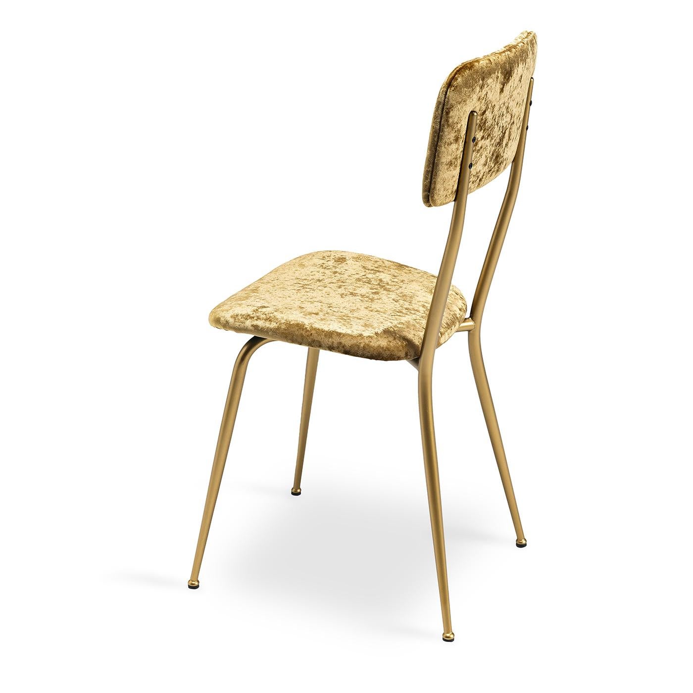 The Miss Ava 12 chair is distinguished a sleek silhouette, boasting clean lines and effortless proportions. Supported by a brushed brass metal frame, its padded seat and backrest are upholstered in luxurious rust-colored velvet fabric. With its